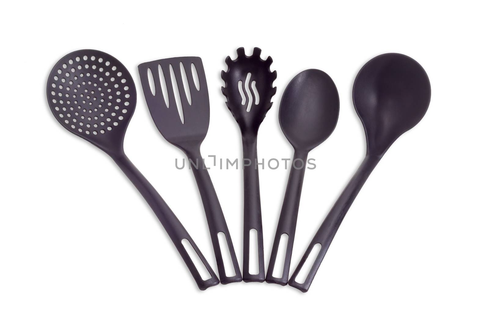 Set of plastic black cooking utensils consisting of skimmer, fish slice, slotted spoon, kitchen spoon and soup ladle on a light background
