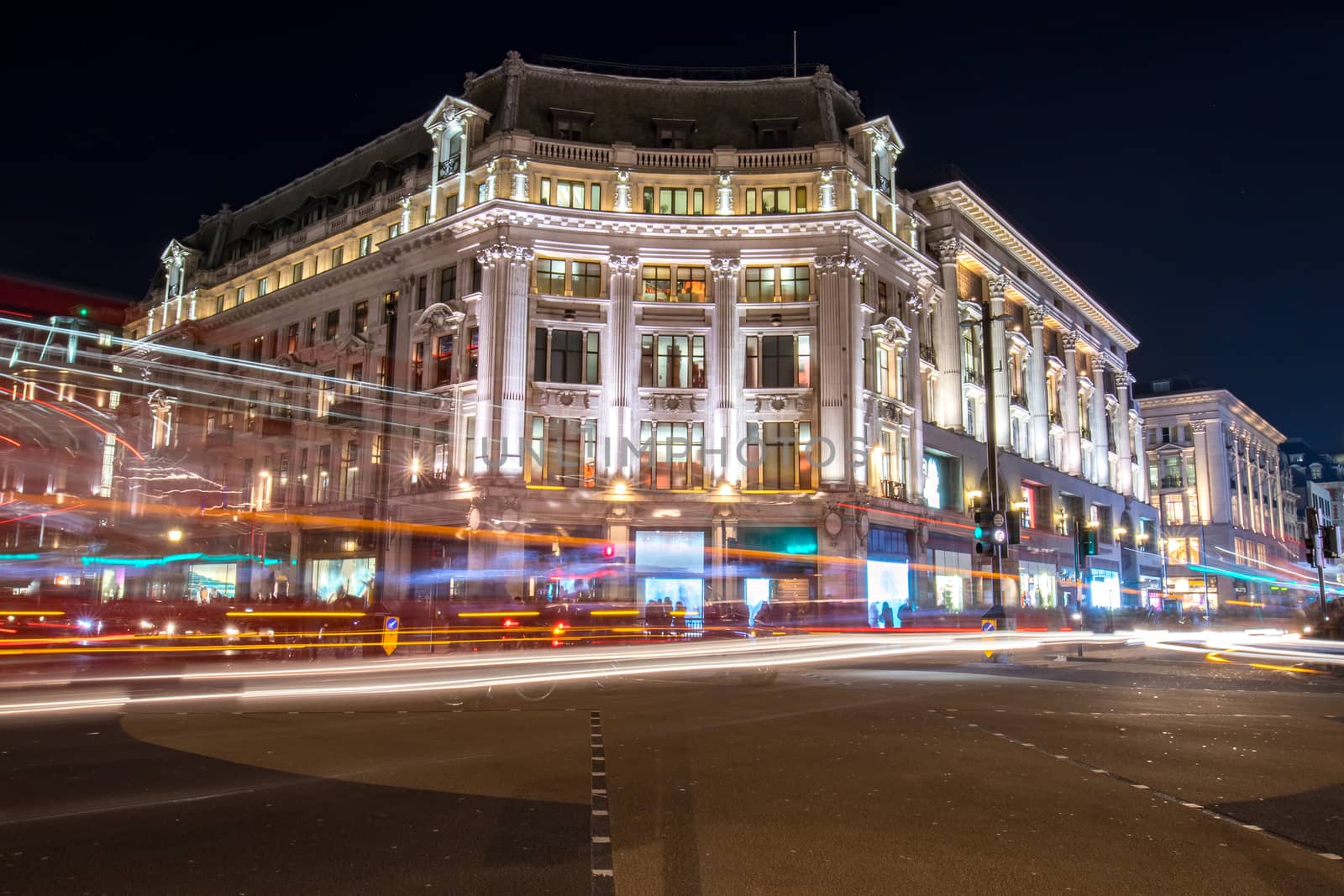 Night view on a corner building in one of the busiest streets in london