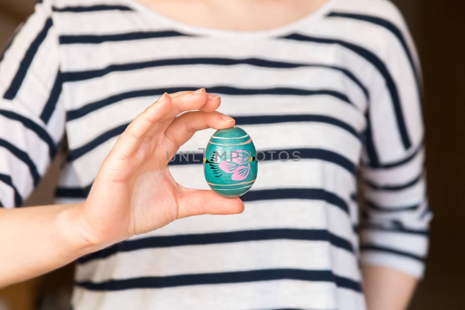 Young woman holding painted easter egg
