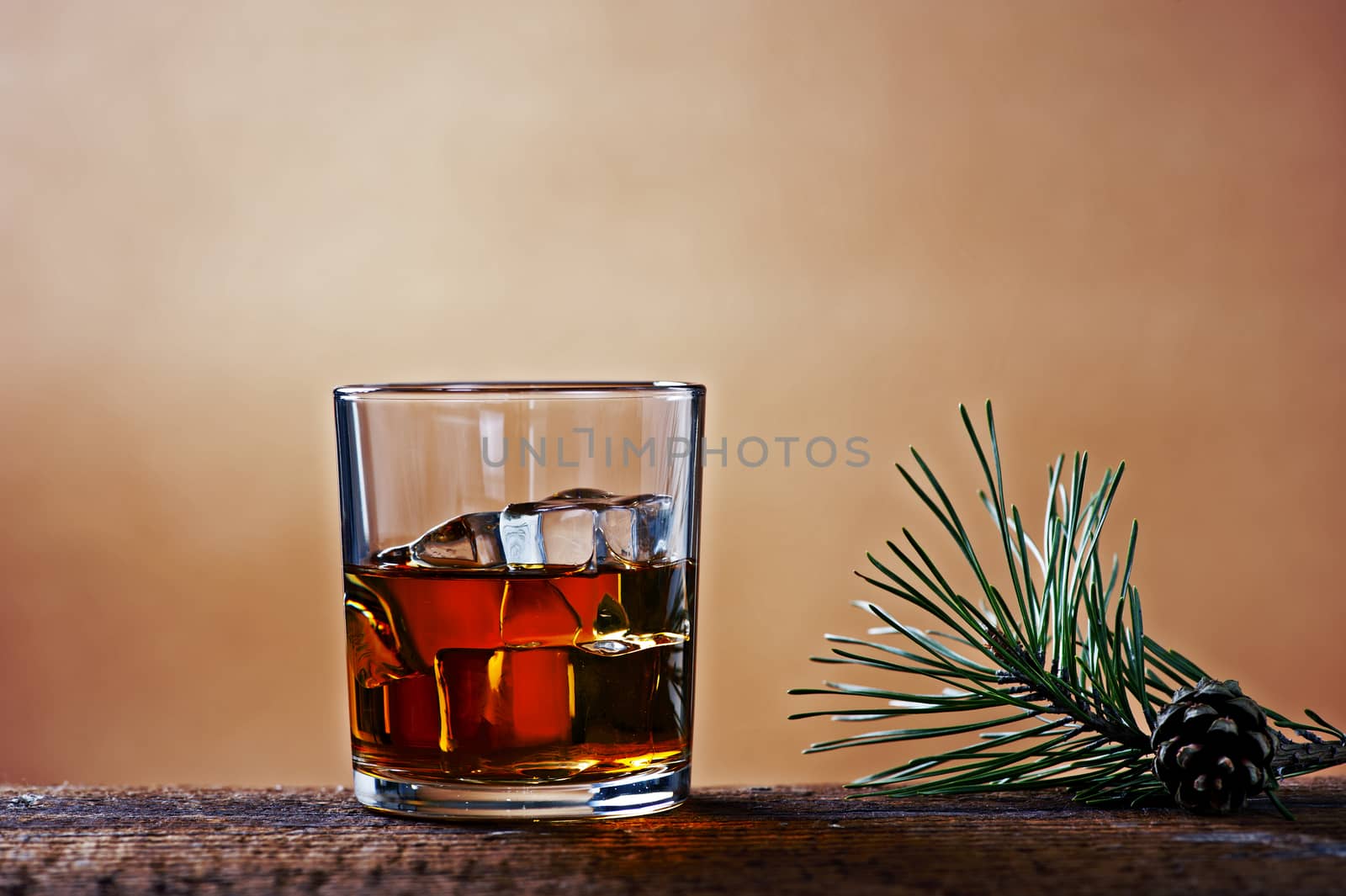 A glass of whiskey on a wooden table