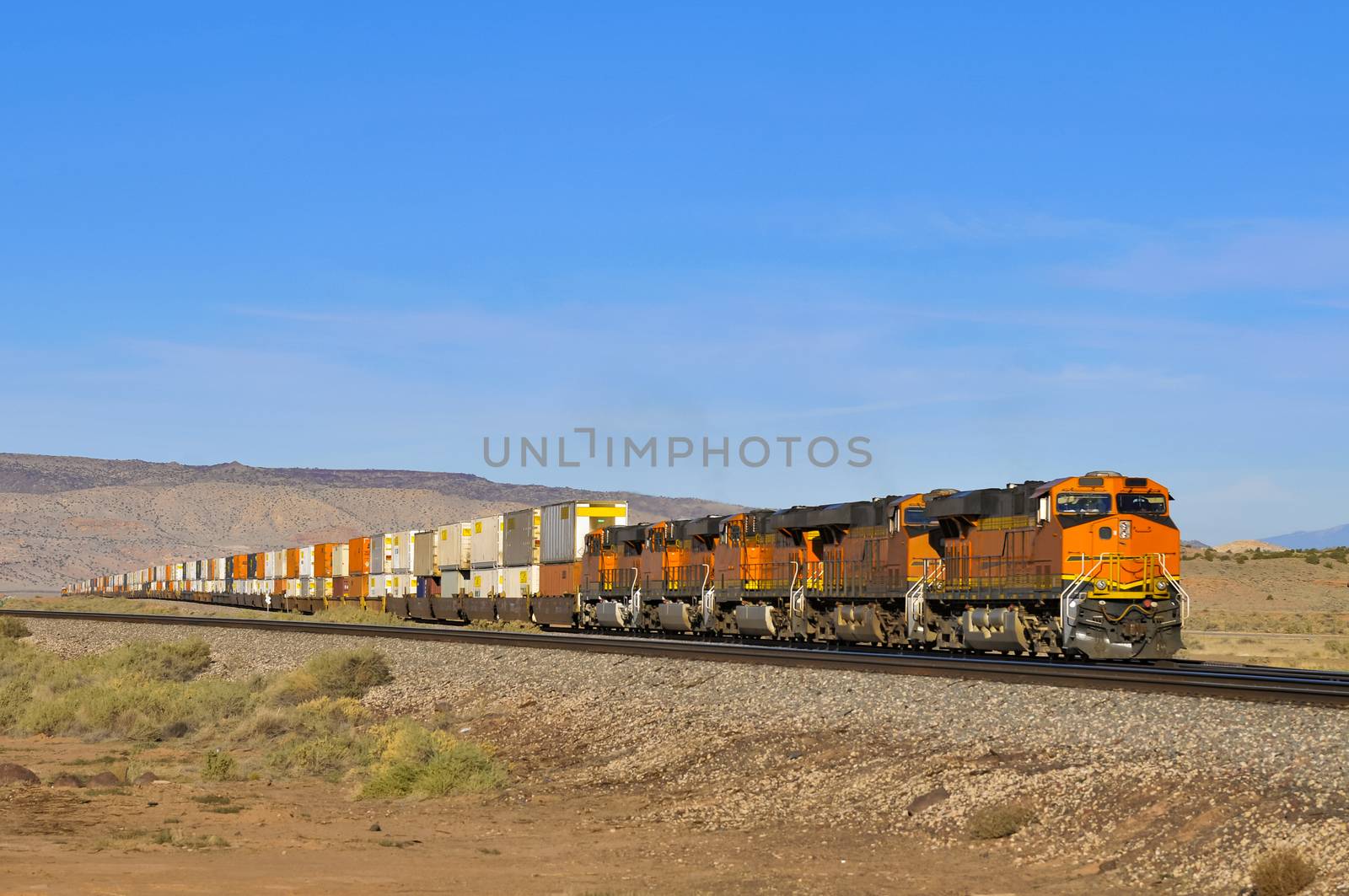 freight train with four locomotives and waggons full of containers in the desert, Arizona, USA