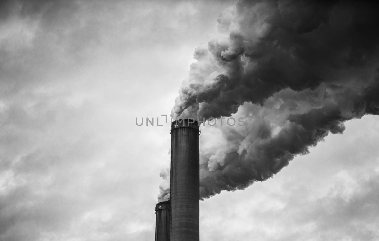 closer up view of smoking smokestacks in Black and White 