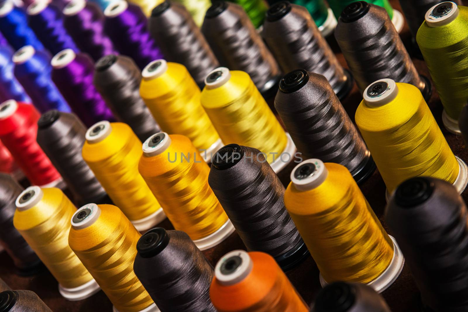 Image of rows of spindles with multicolored threads