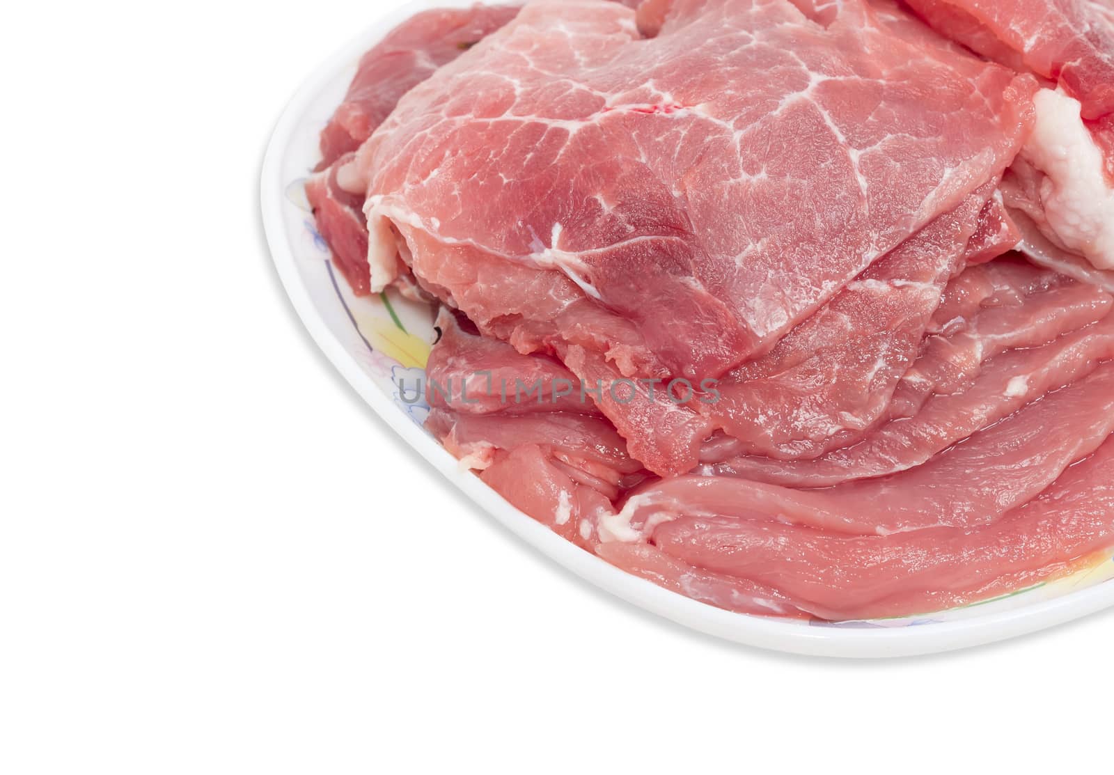 Sliced uncooked pork on dish closeup by anmbph