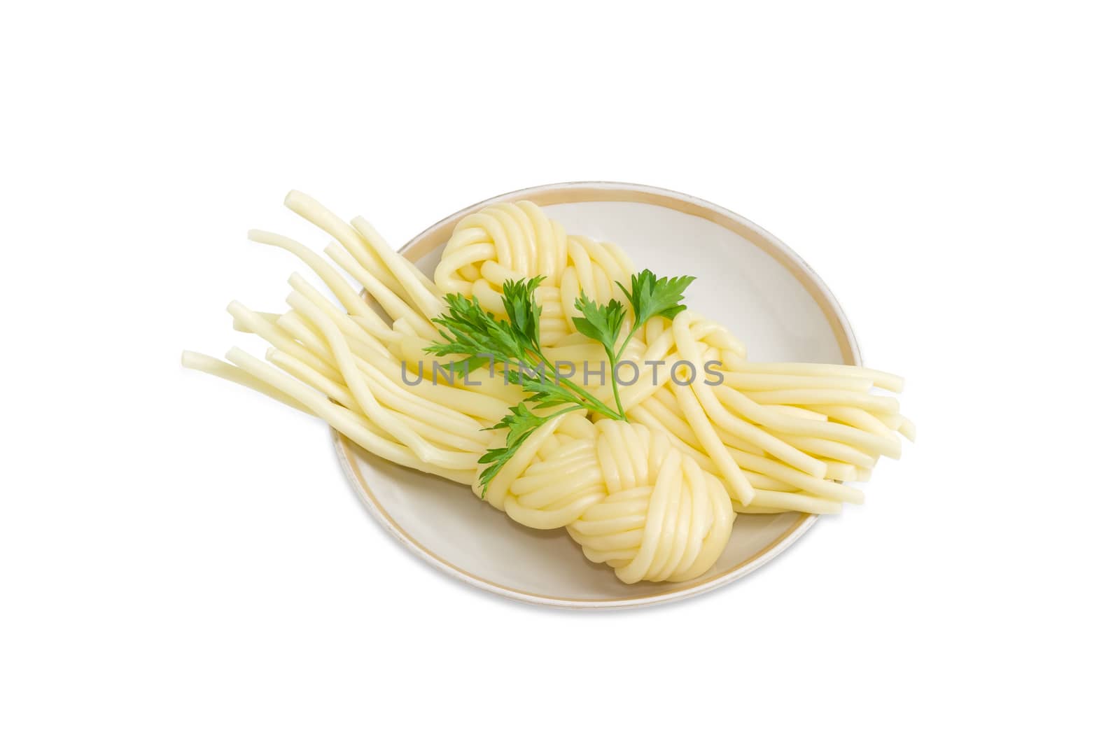 Two portions of the mozzarella cheese in the form of strings, twisted in a shape of a plait and twig of parsley on the saucer on a light background
