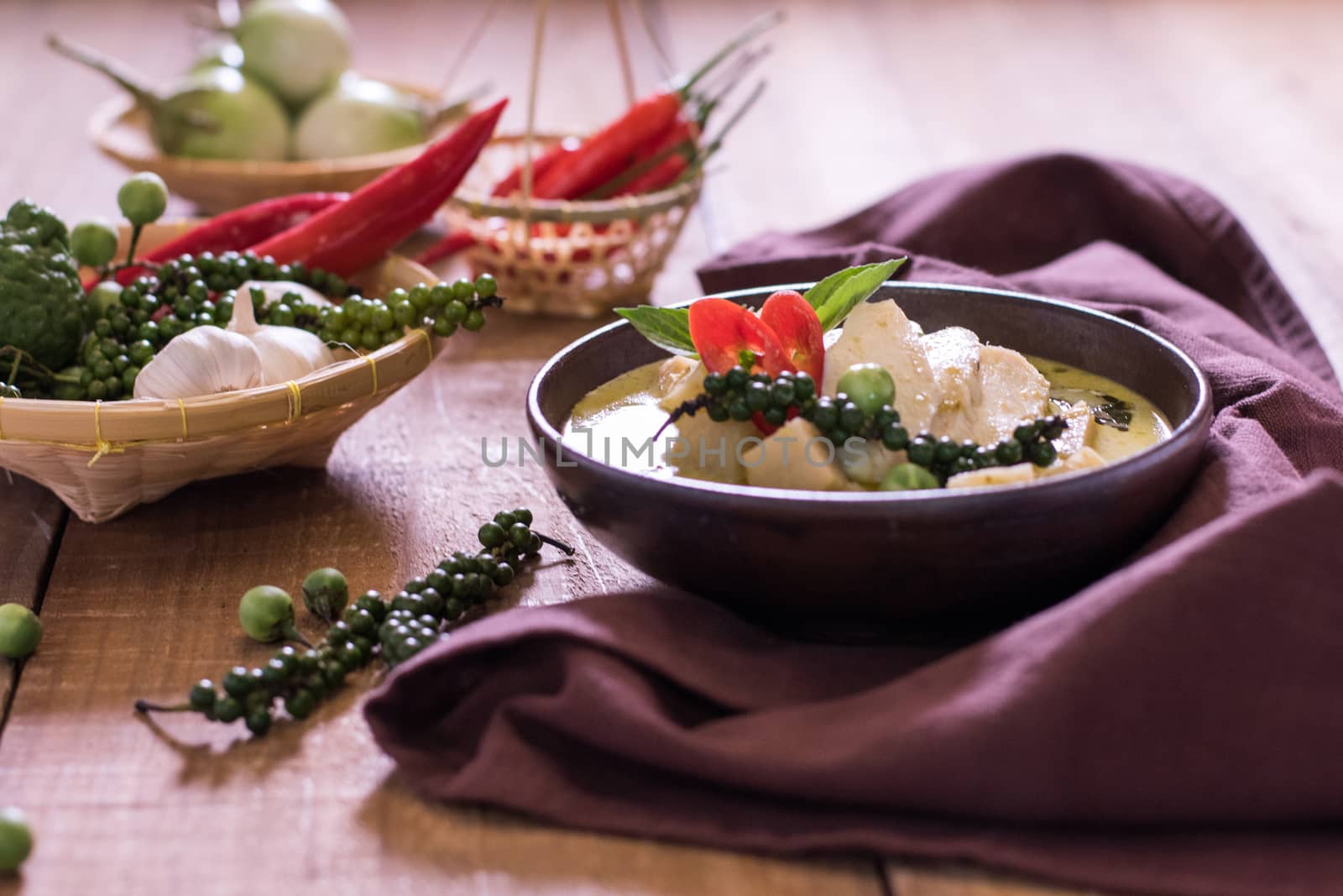 Chicken mussaman curry in bowl vegetables on wooden background by dfrsce