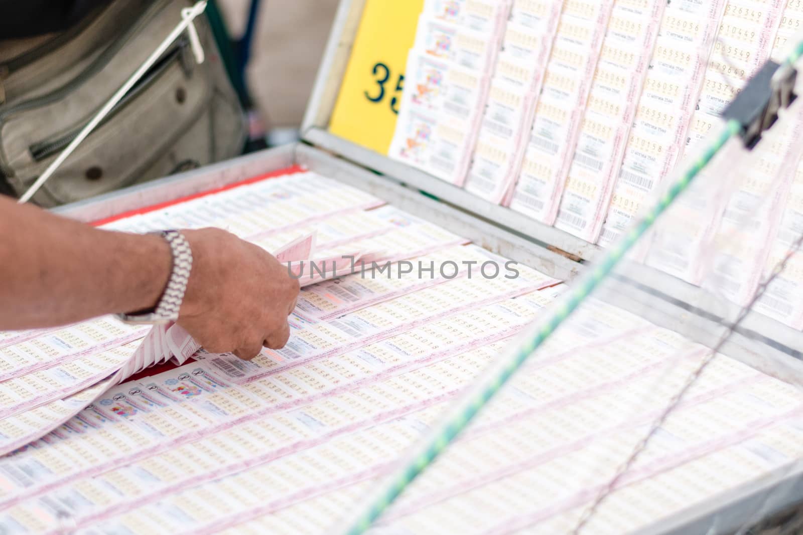 Man buying lottery at the counter. Thai lottery offers a form of by dfrsce