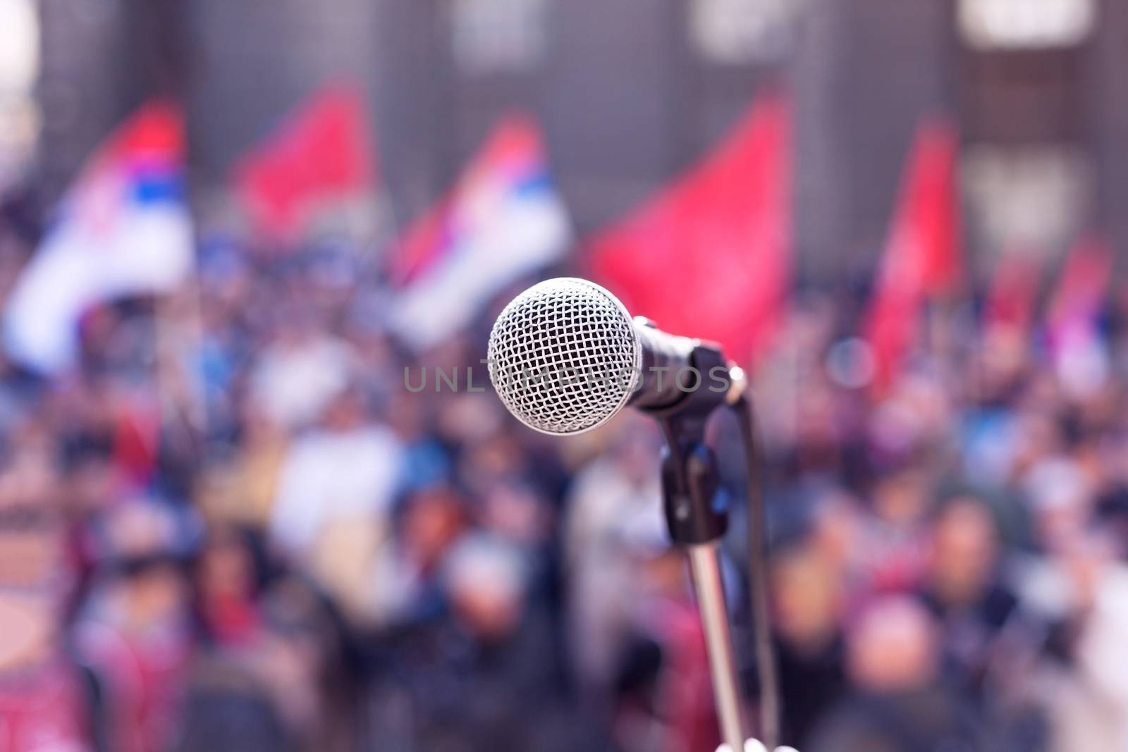 Microphone in focus against blurred crowd