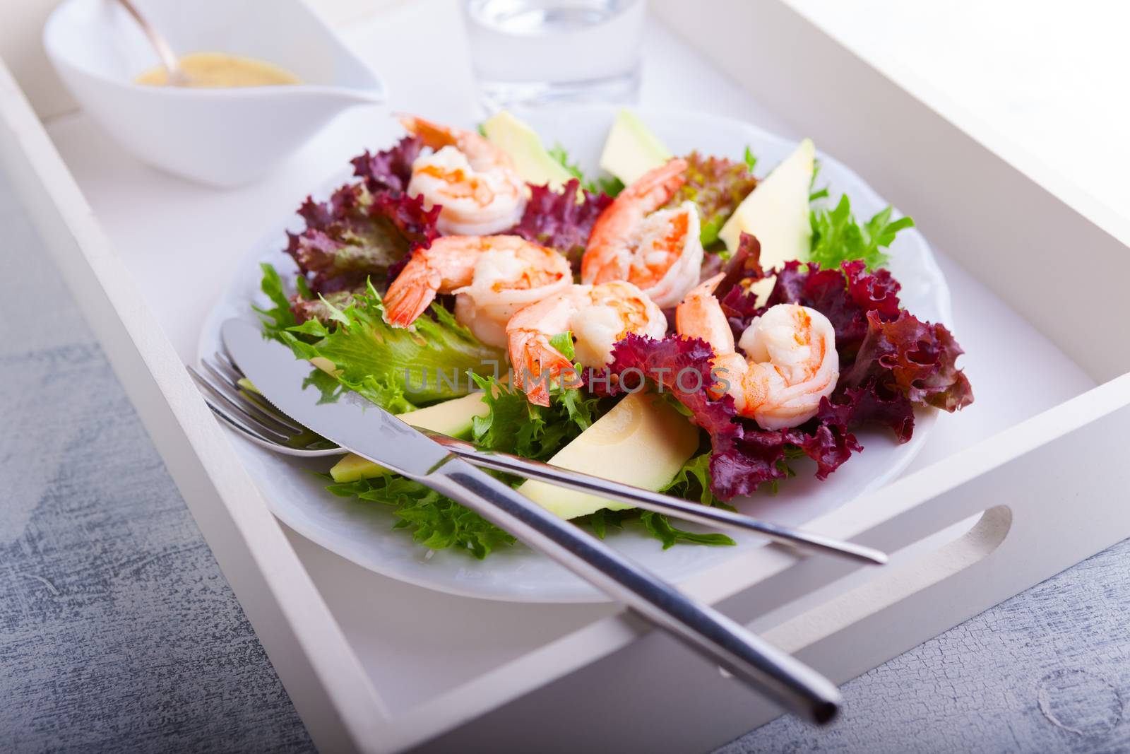 Avocado shrimp salad with mustard sauce on a tray by supercat67