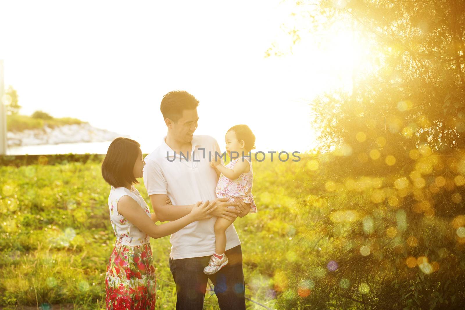 Family having fun at outdoor sunset by szefei