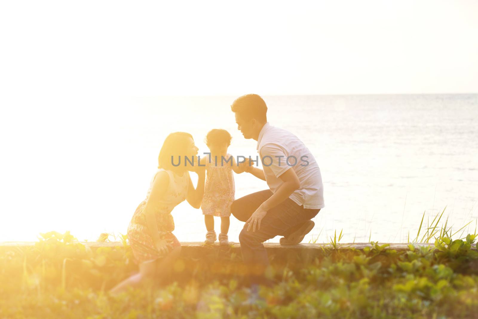 Family outdoor fun in sunset at seaside by szefei