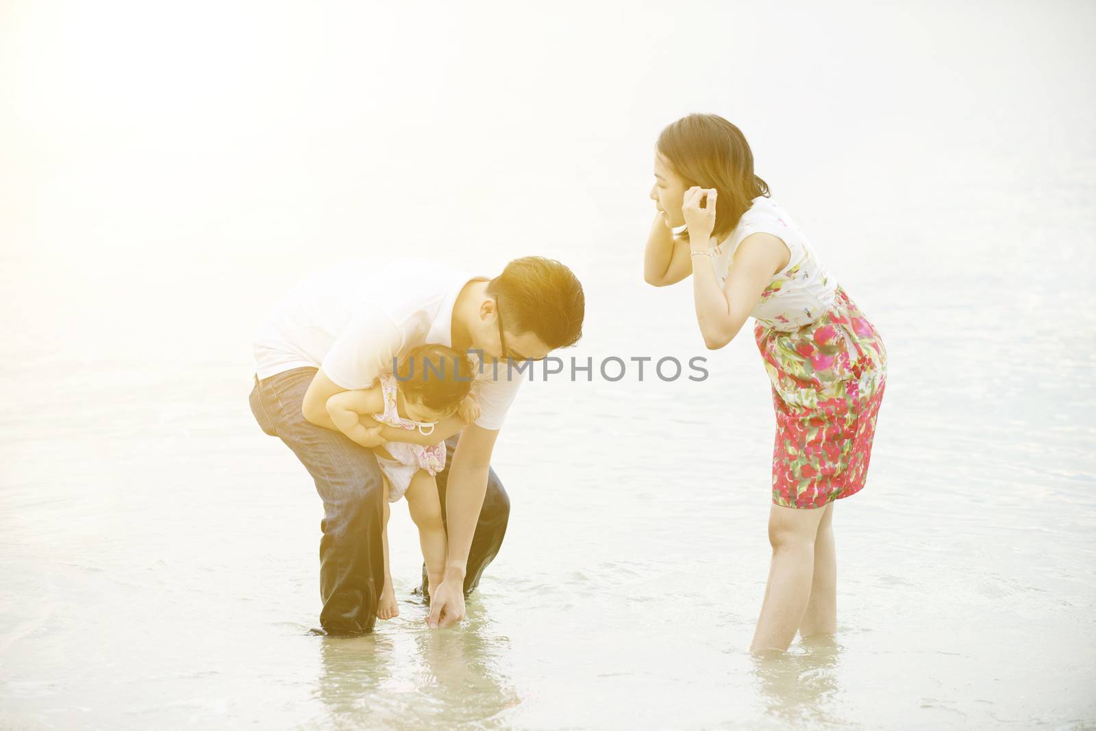 Family playing on beach by szefei