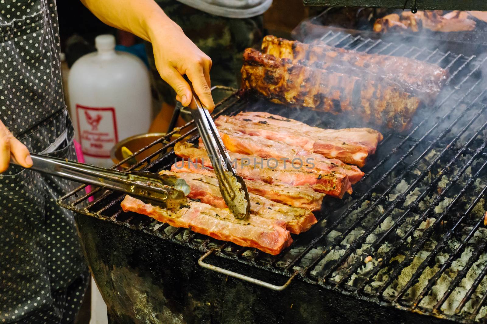 Grilled meat on the barbecue rack outdoor food items set. Street food BBQ grill tools. Concept of eating outdoors in the weekend.