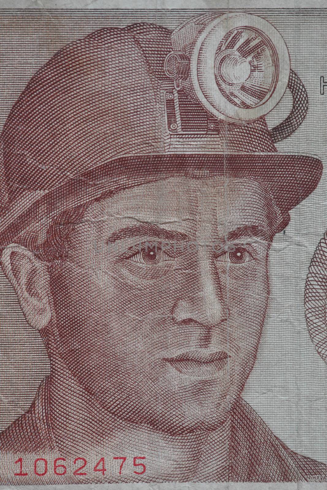 Miner in a helmet with a lantern portrait on a banknote
