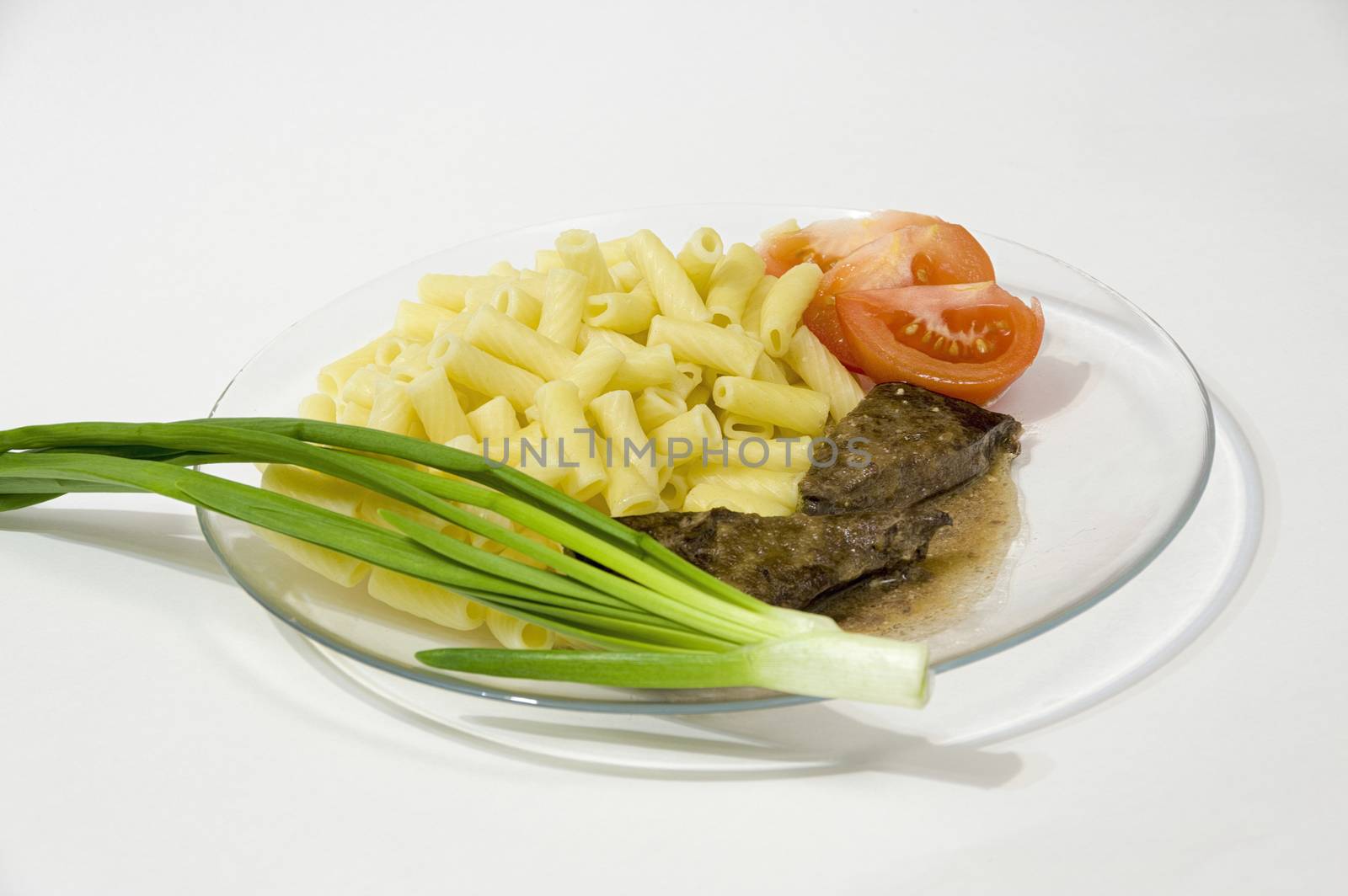 grilled beef liver with pasta sauce onions and tomatoes on a plate