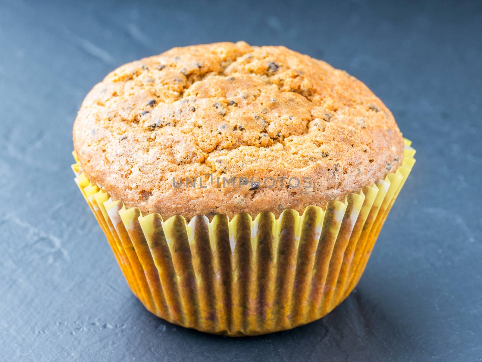 Muffin with chia seeds and lemon. Homemade muffin on black background