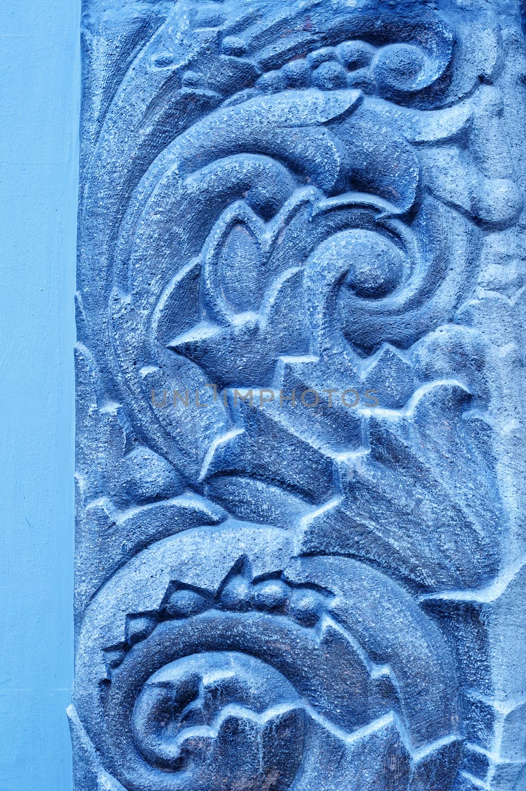 blue plaster mural on a wall background.