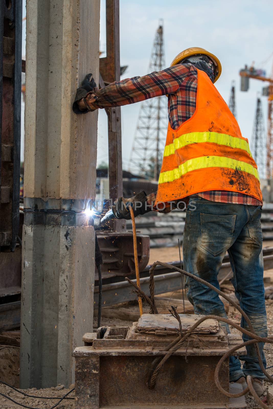 welder at construction site by antpkr