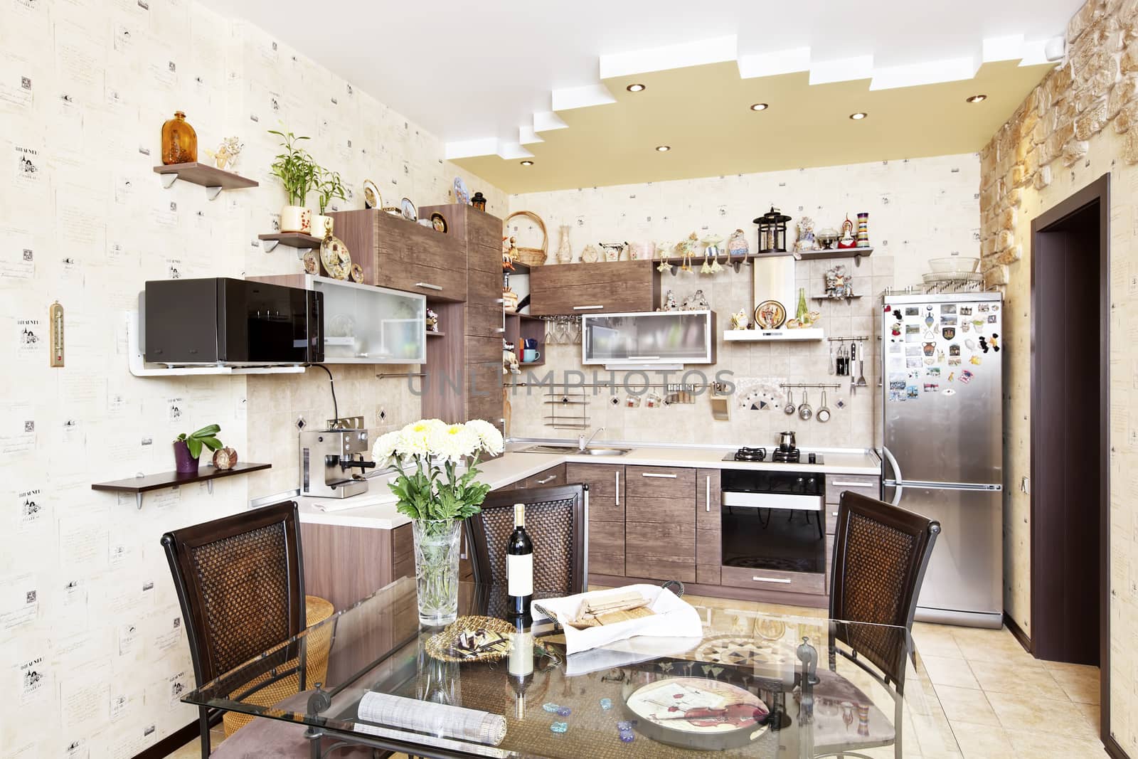 Beautiful wooden kitchen with dinner table and stone decors by RawGroup