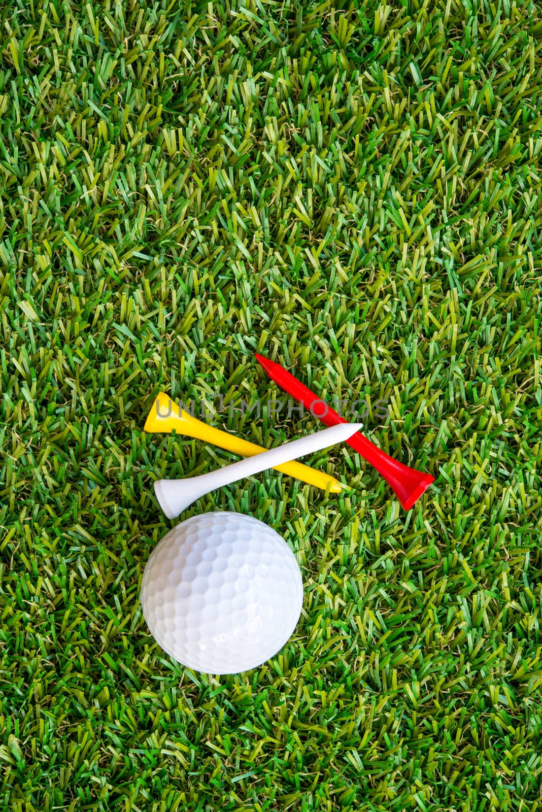 golf ball and tee on grass