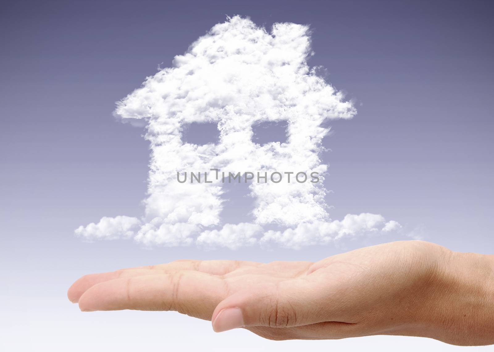 Hand holding dream home by unikpix