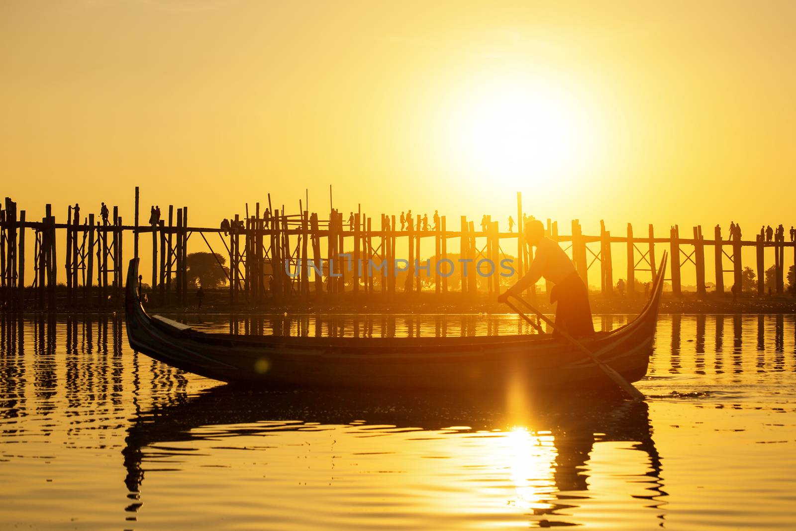 Fishman under U bein bridge at sunset, Myanmar landmark in mandalay