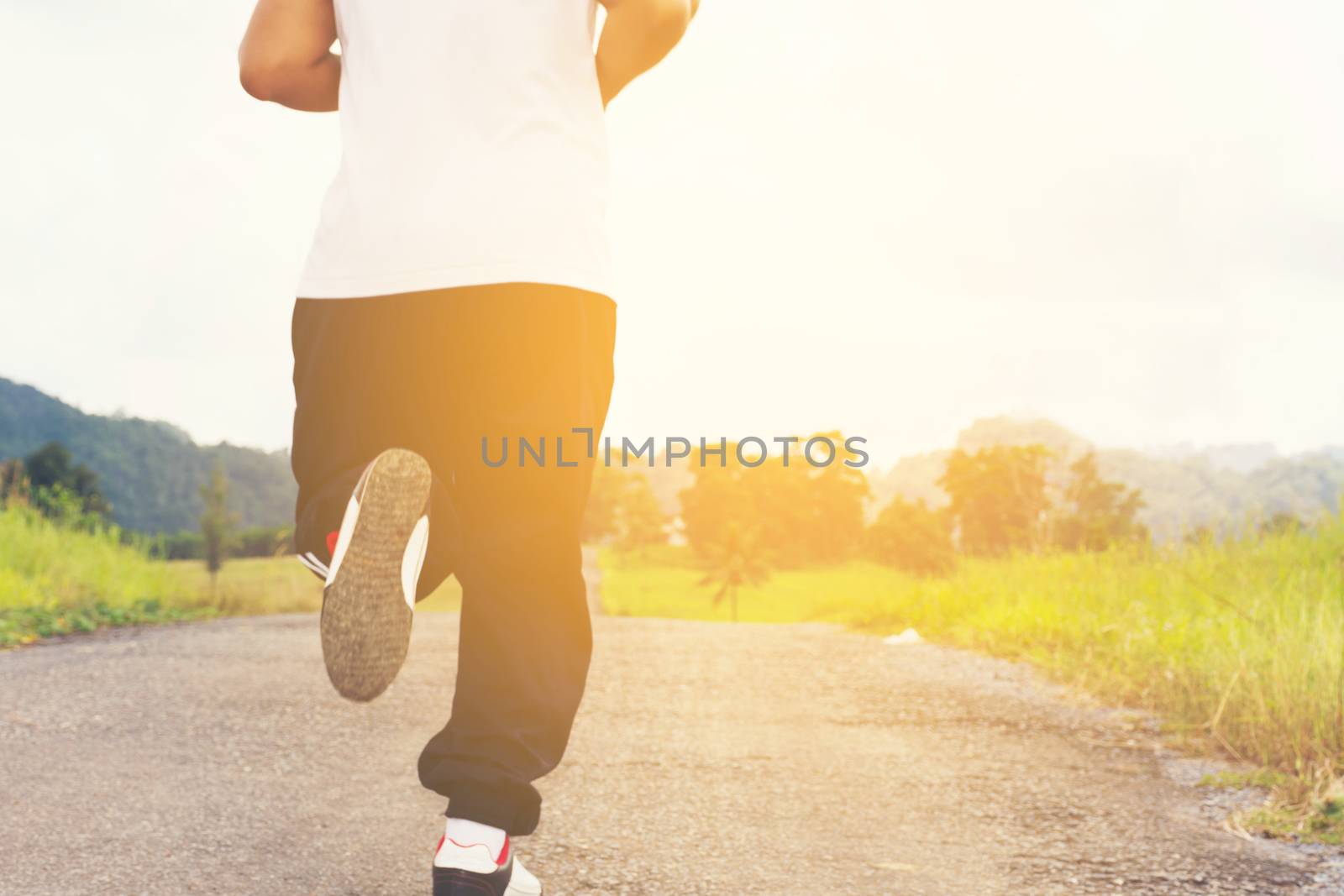 Man running   and nature background view.Back of a man1