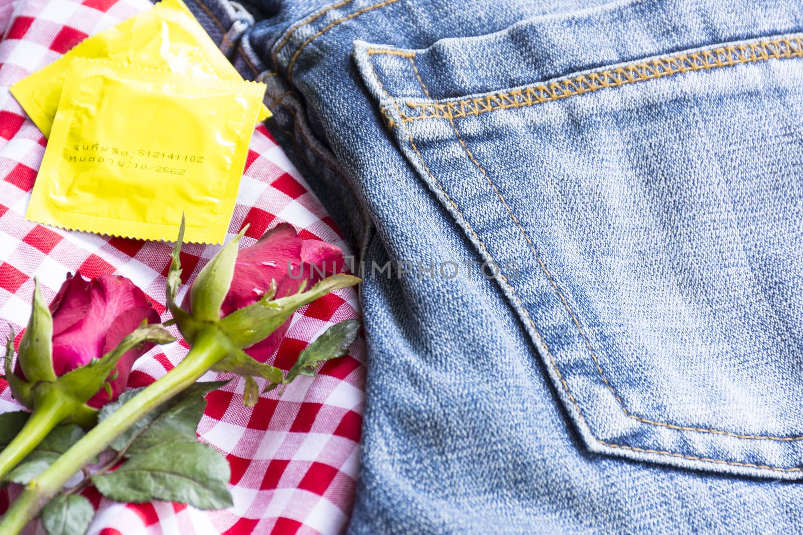 Pack condoms  with roses and jean.Sex or story valentine day.Close up by engphoto