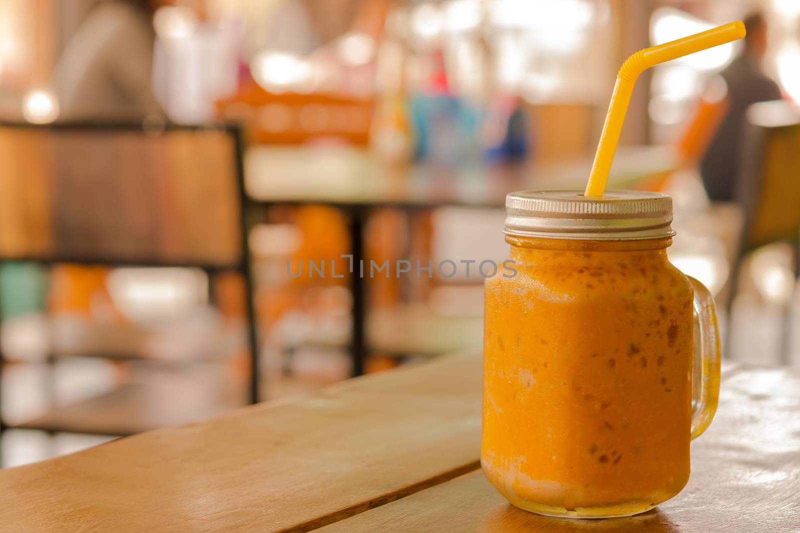 Ice tea in mason jar on table and background of restaurant in Asia. by engphoto
