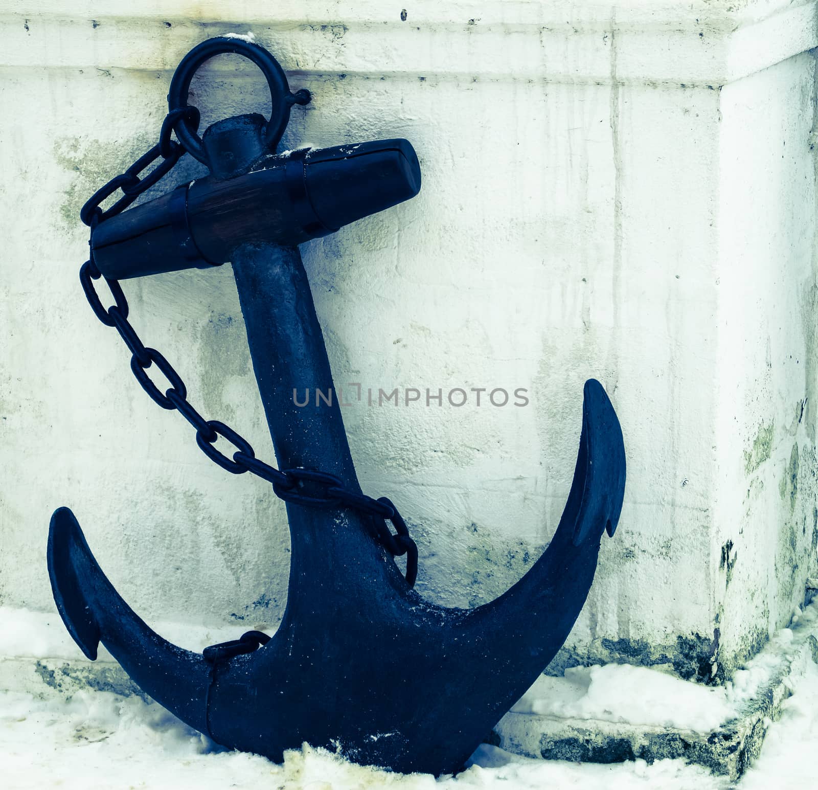 black anchor on a background of white snow