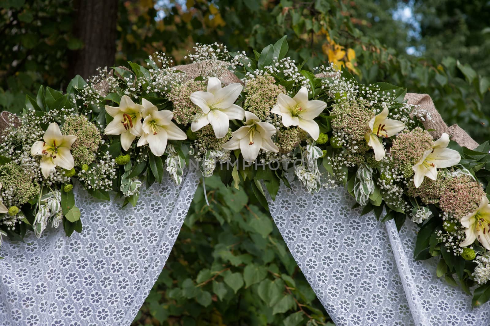 wedding arch decorated with white flowers lilies by timonko