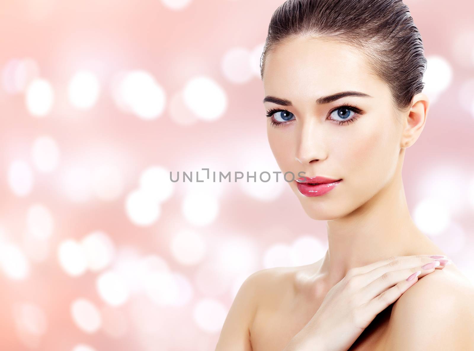 Young beautiful woman portrait, abstract background with blurred lights