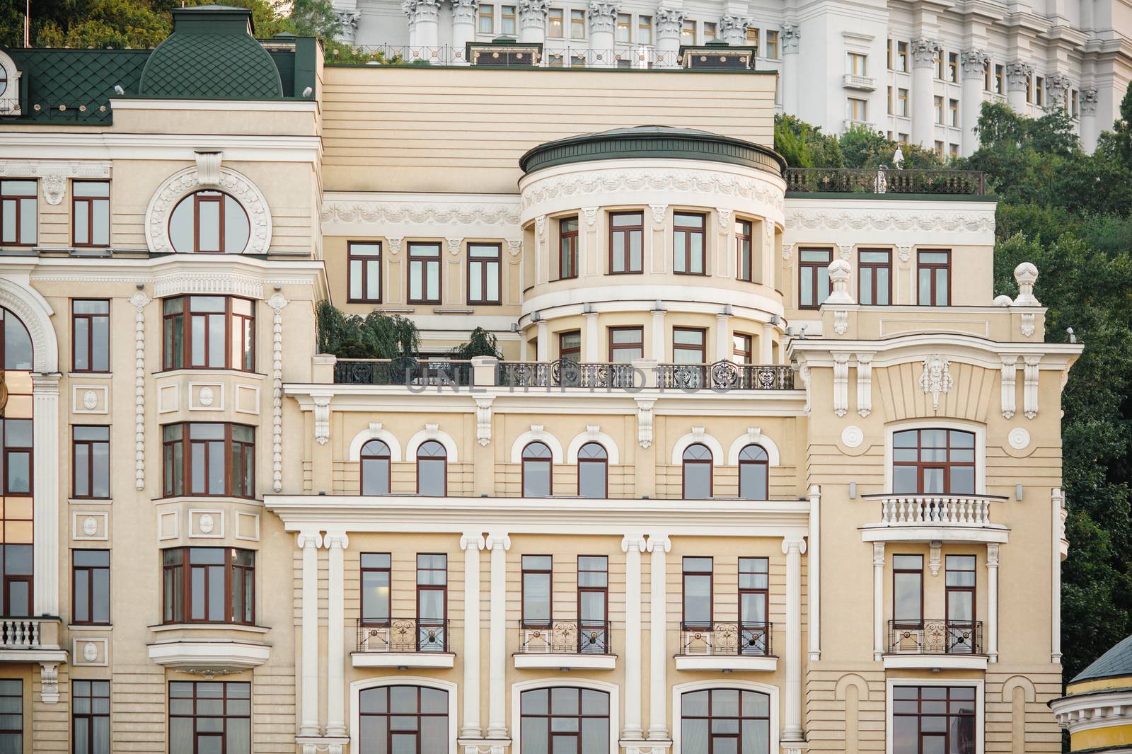 beige multi-storey old building with windows in city.