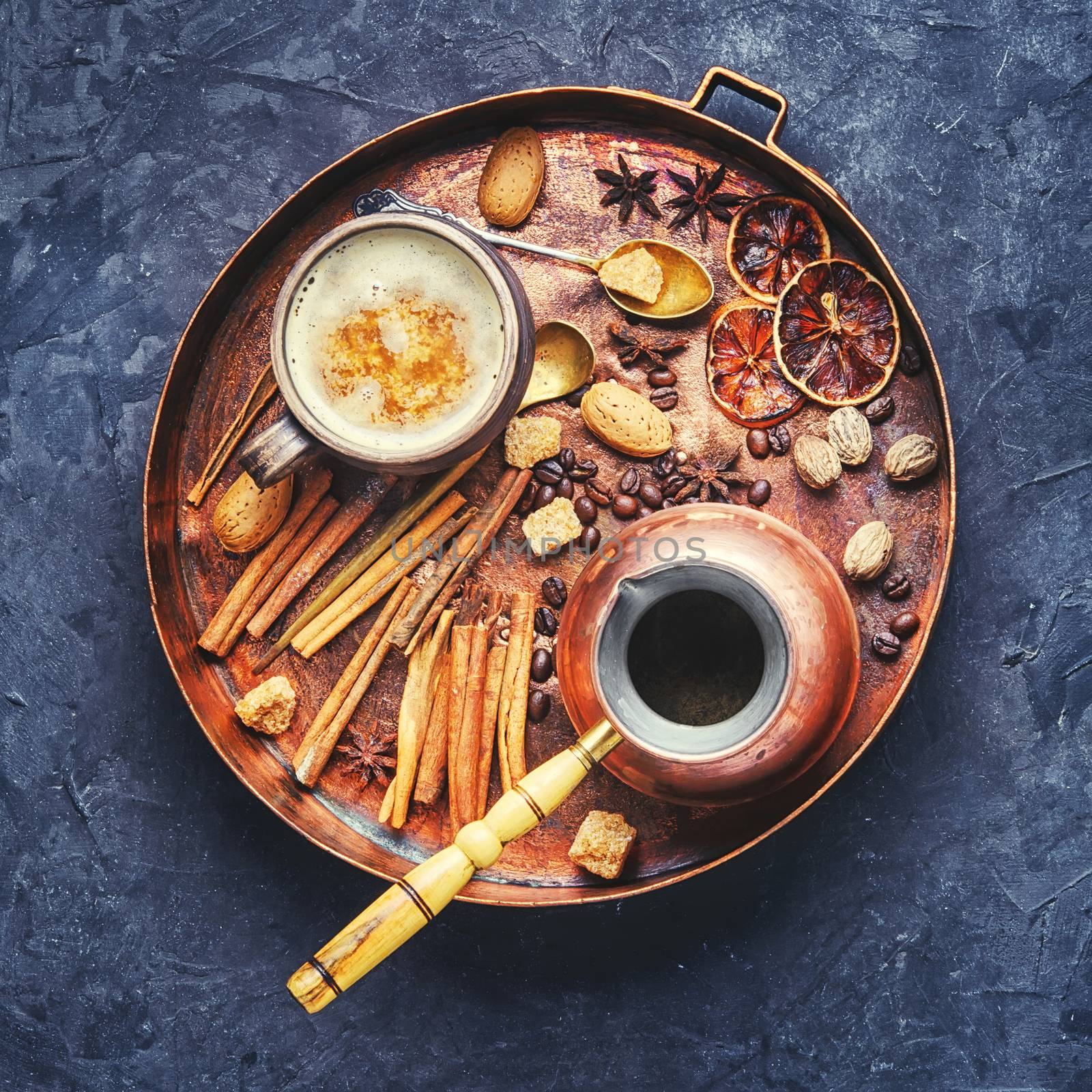 cezve and cup of coffee in copper tray with oriental spices