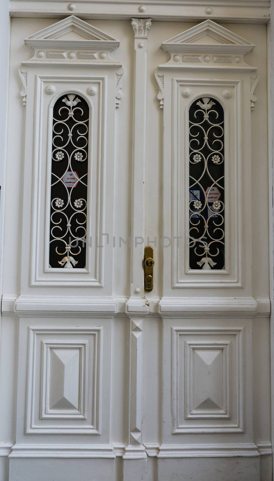 White decorated door into a large house