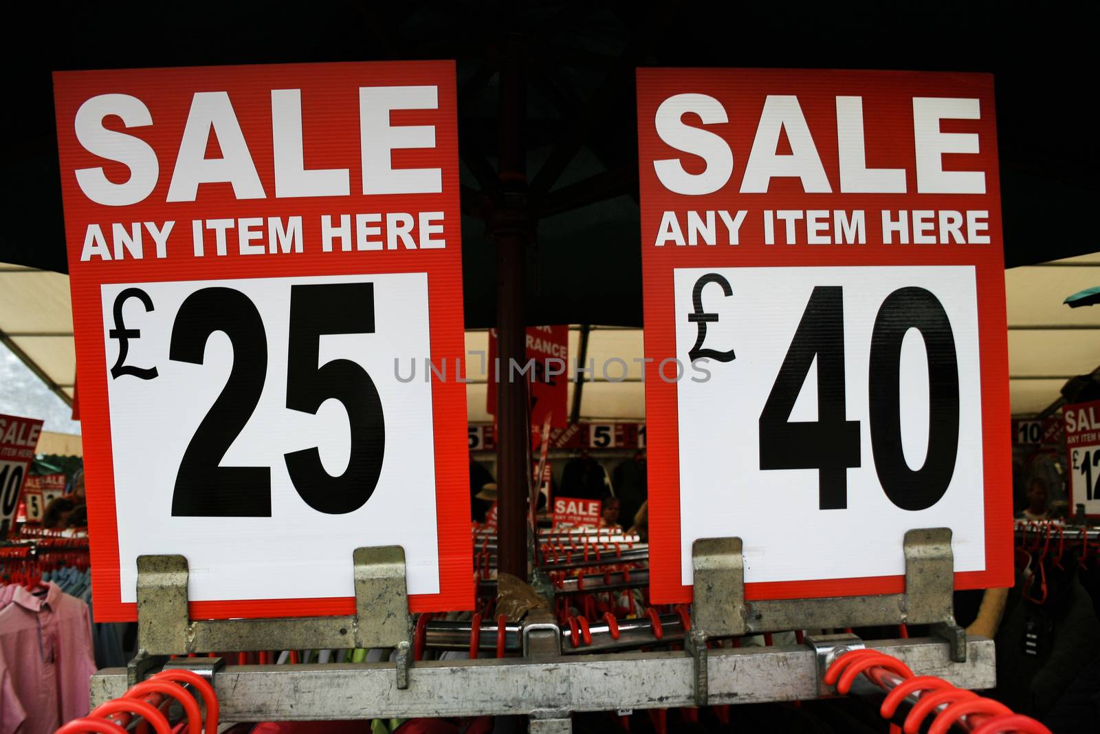 2 sale signs in a clothing area