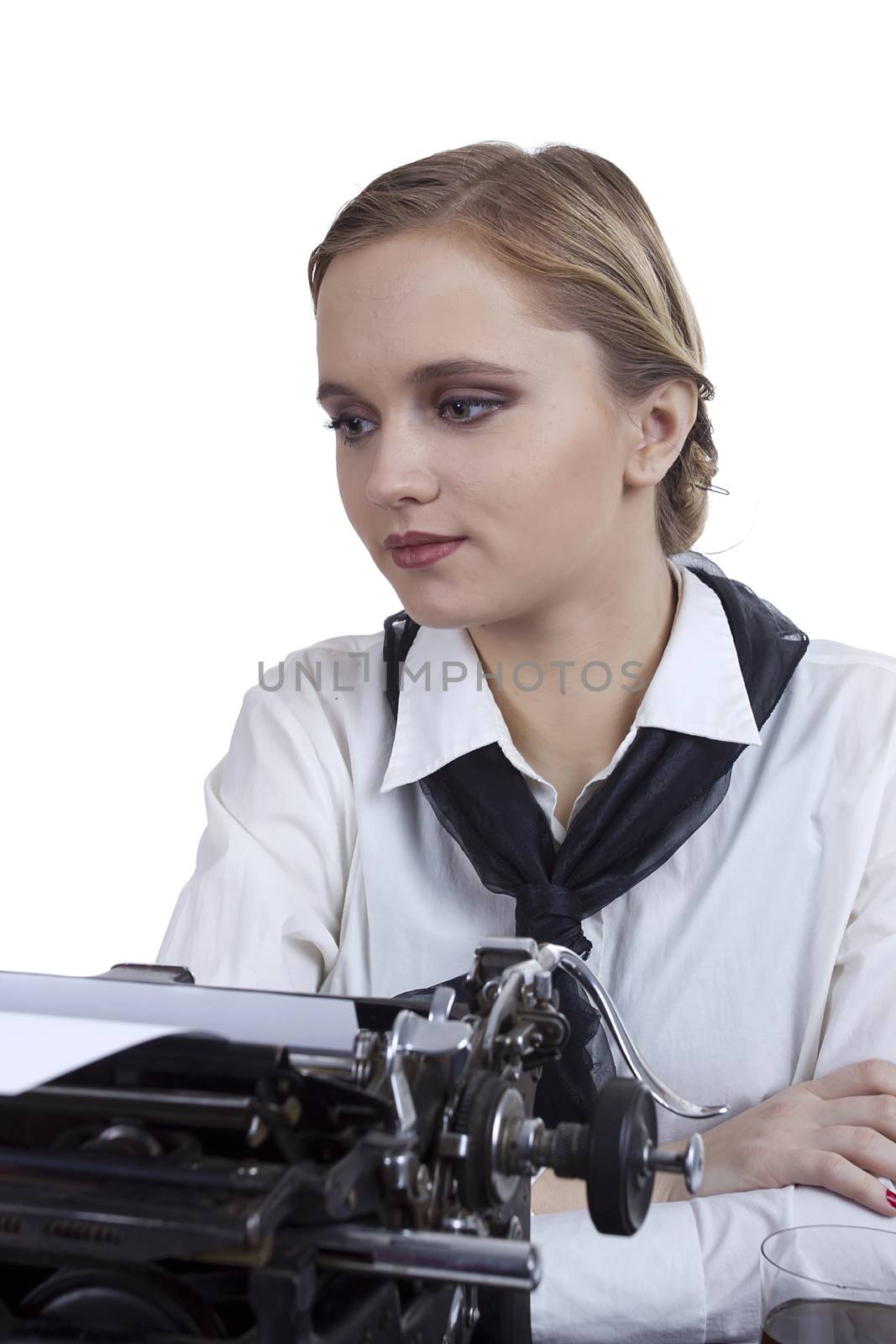 Young girl typist with an old typewriter on a white background