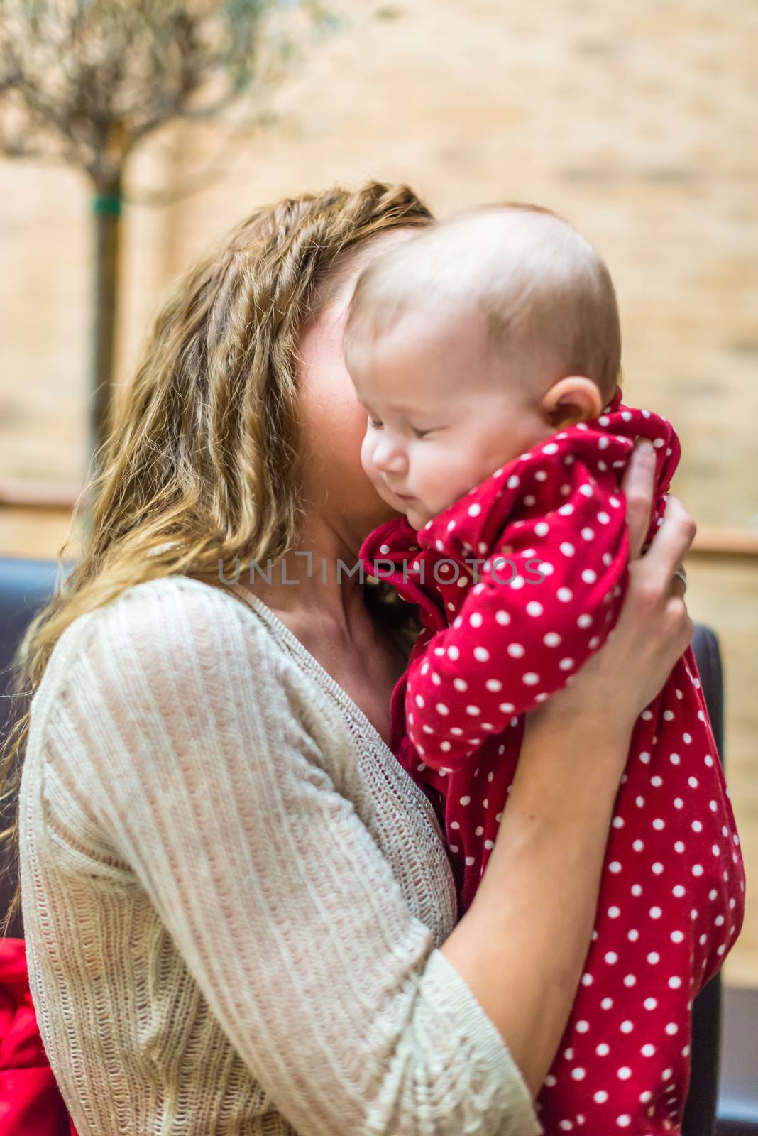 happy mother with a baby in her arms in the room