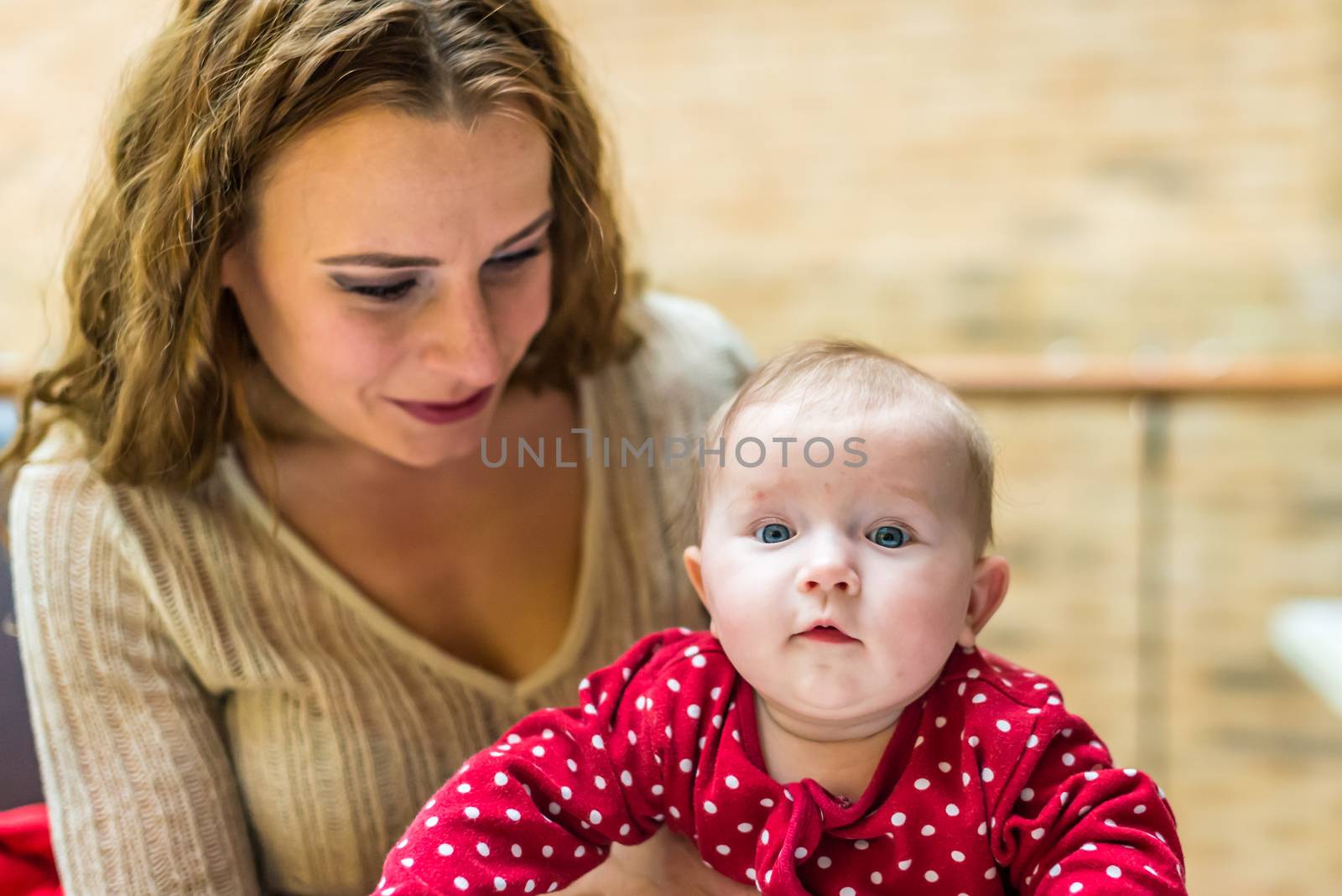 happy mother with a baby in her arms in the room