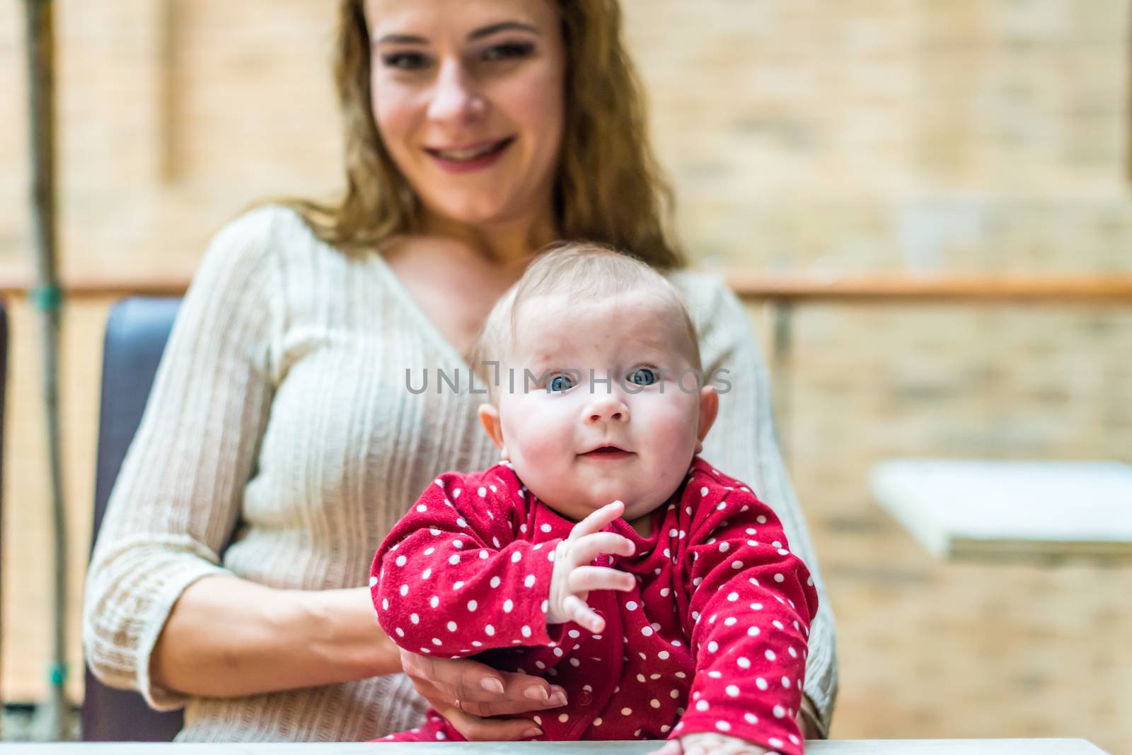 happy mother with a baby in her arms in the room