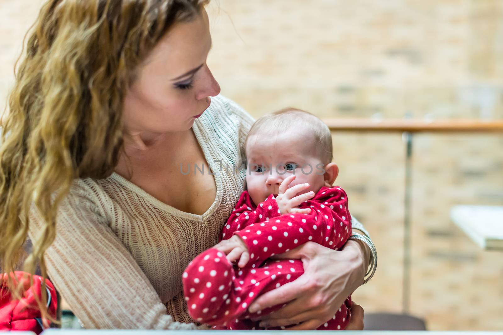 happy mother with a baby in her arms in the room