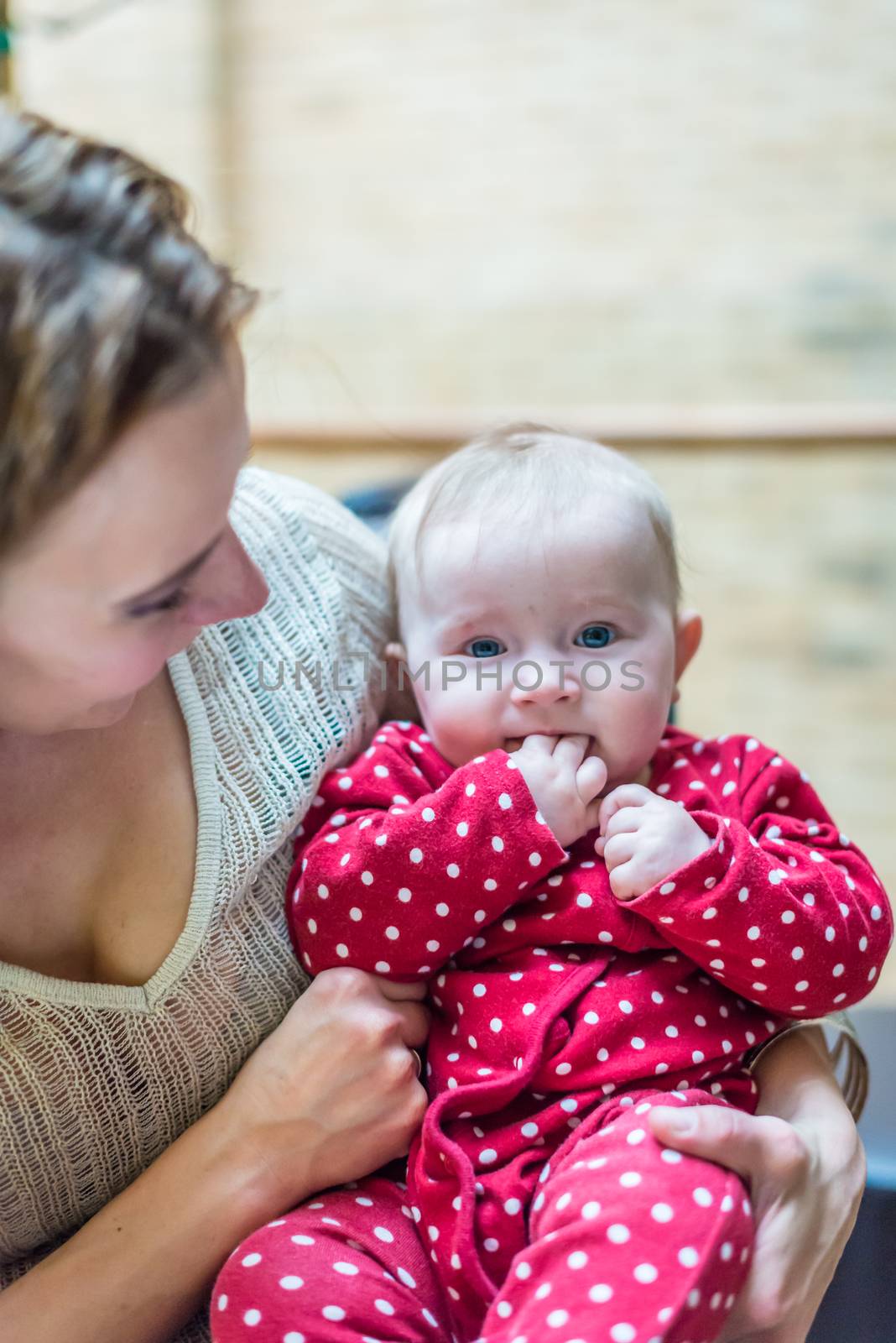 happy mother with a baby in her arms in the room