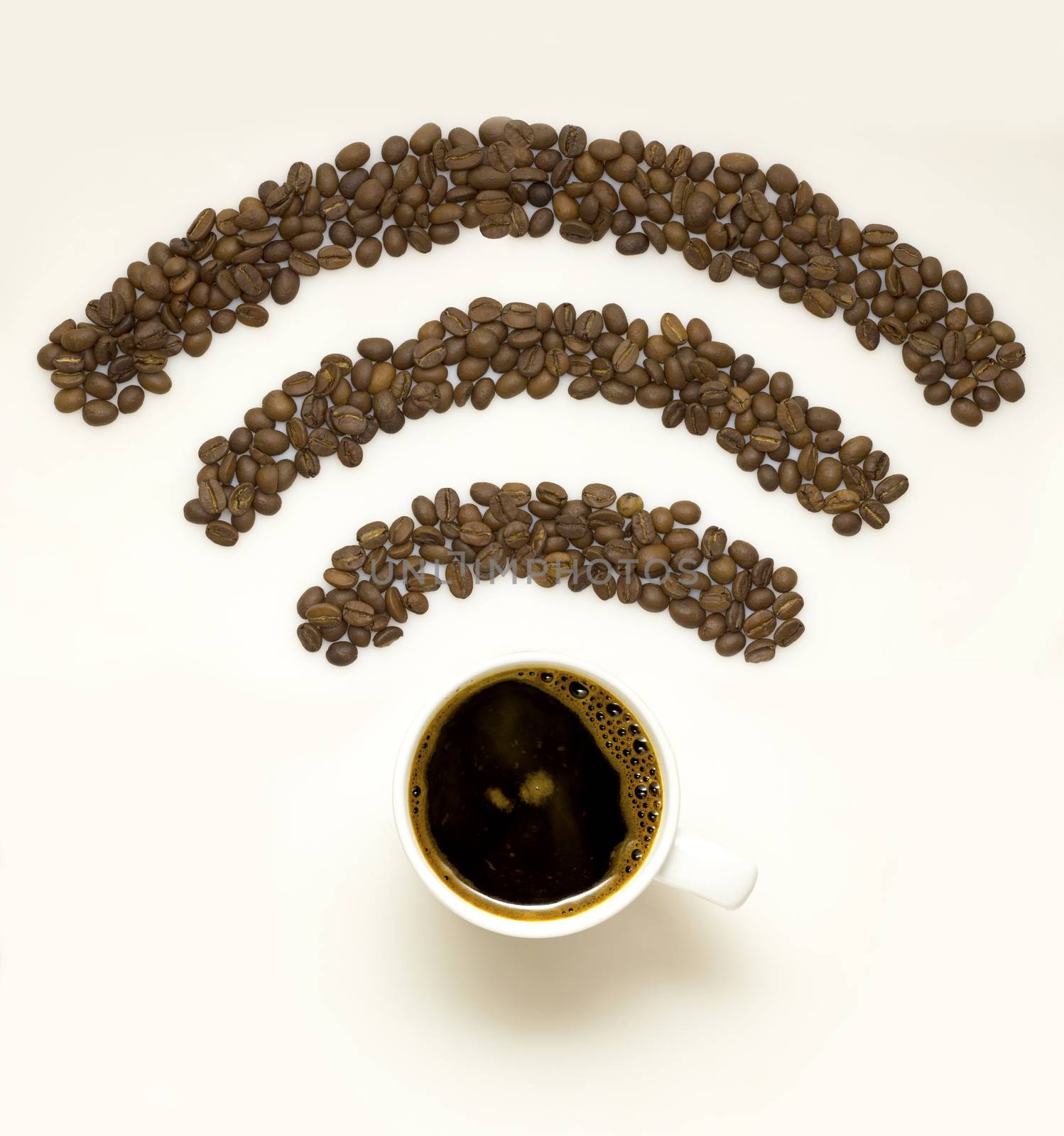 Creative concept photo of  a cup with coffee beans in the shape of wi-fi sign on white background.