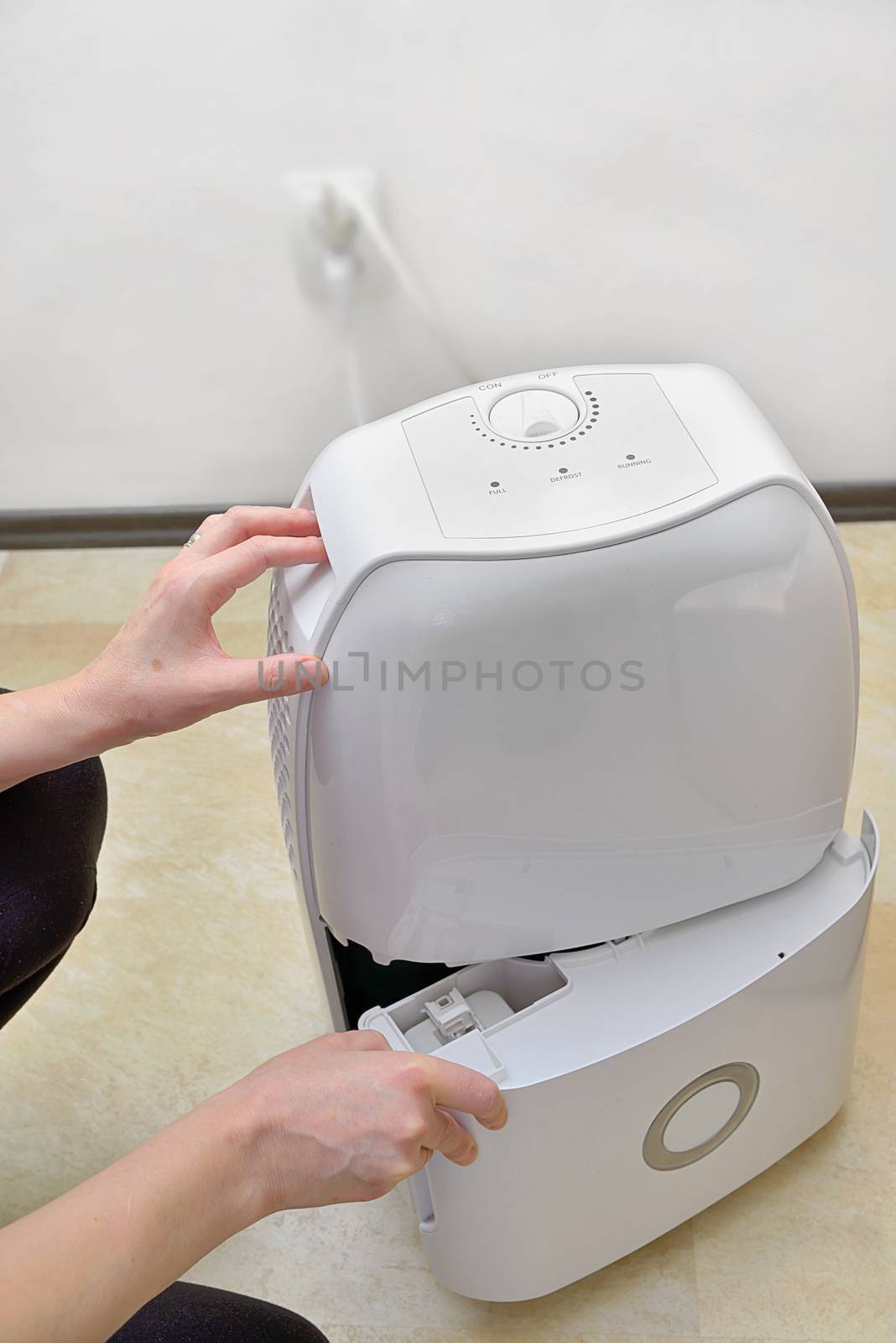 Portable dehumidifier colect water from air inside of living room