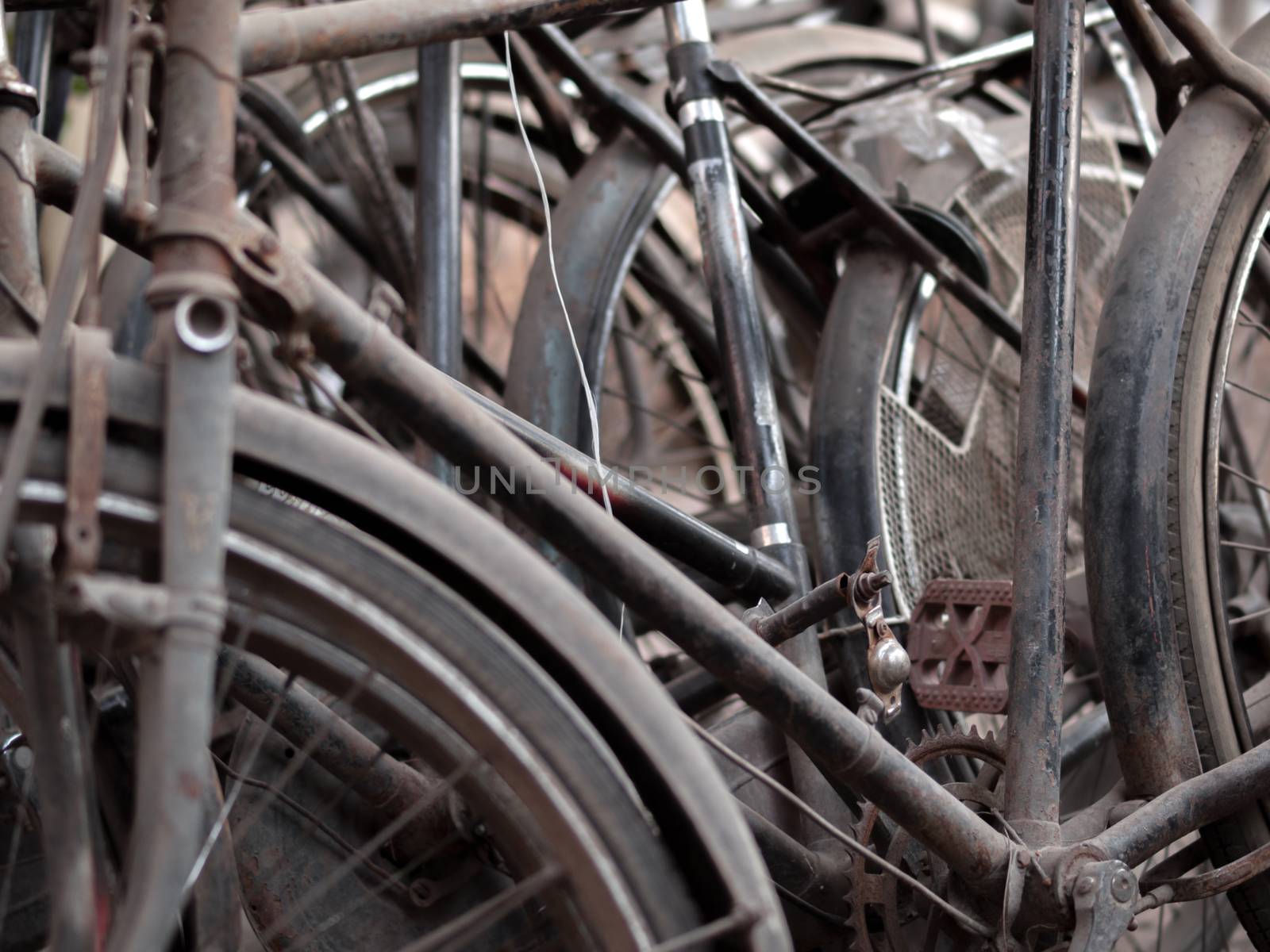COLOR PHOTO OF ABSTRACT SHOT OF OLD RUSTY BICYCLE PARTS