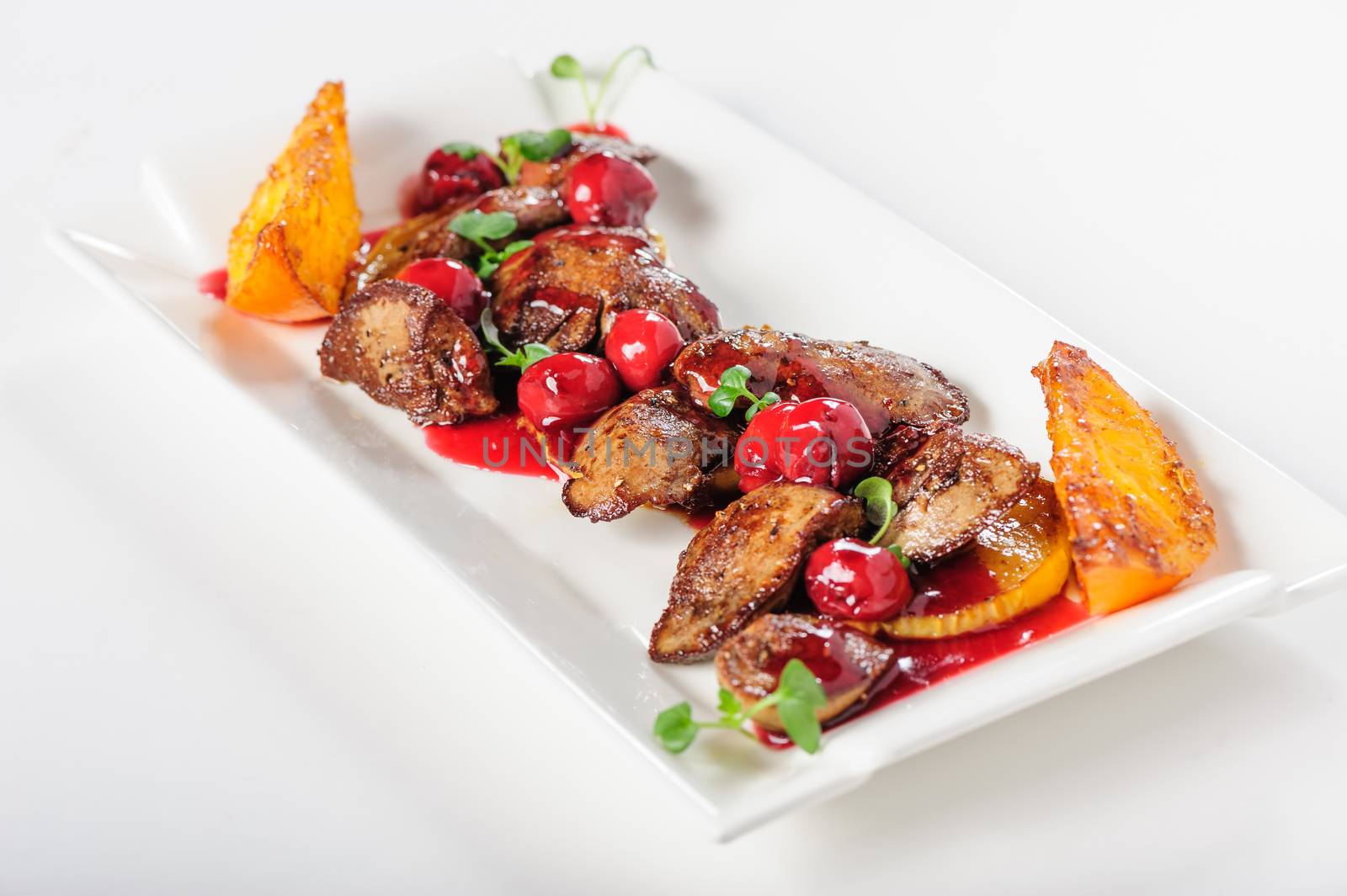 Grilled chicken's liver with chery tomato and other vegetables. Selective focus.