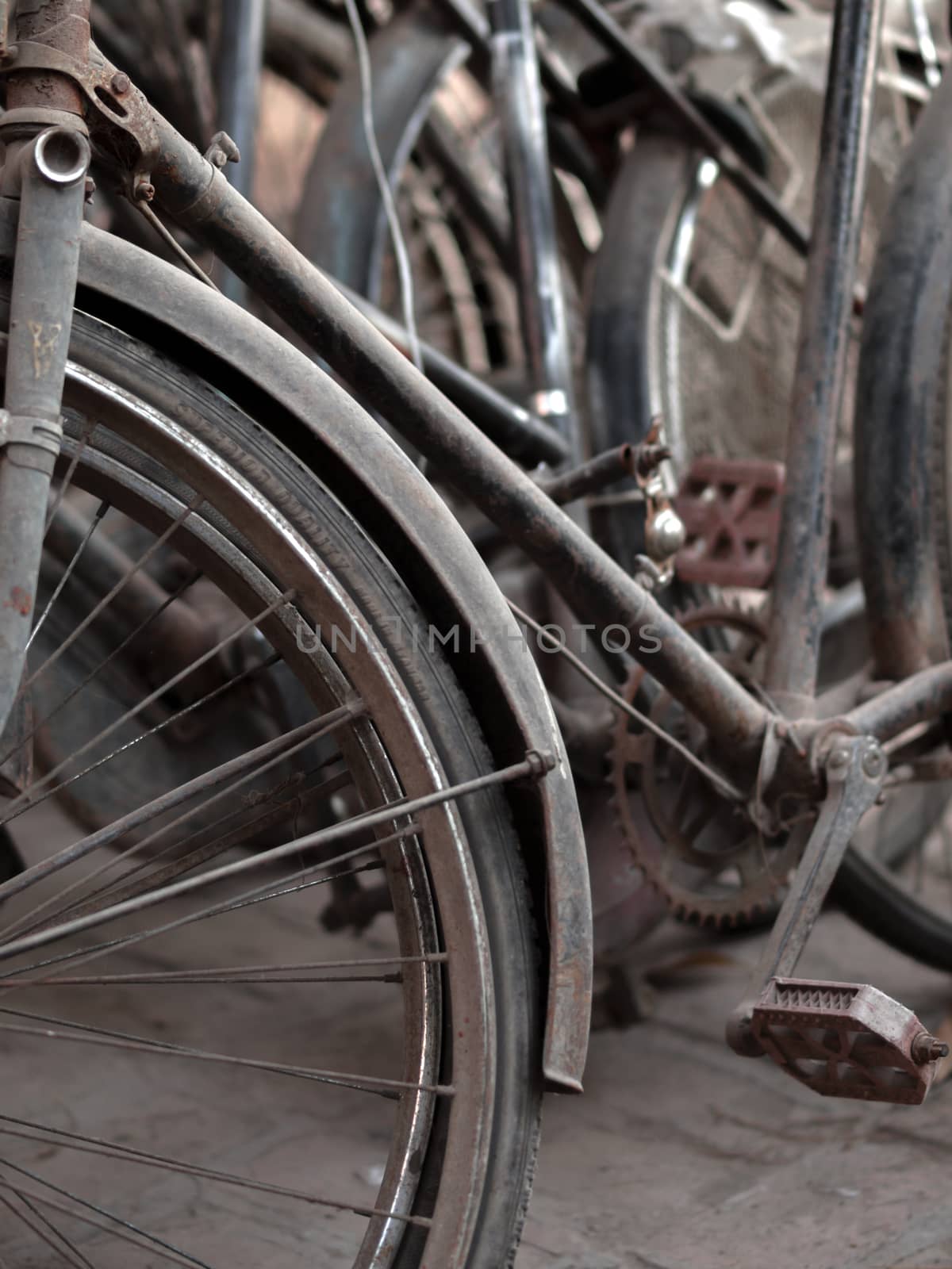 COLOR PHOTO OF ABSTRACT SHOT OF OLD RUSTY BICYCLE PARTS