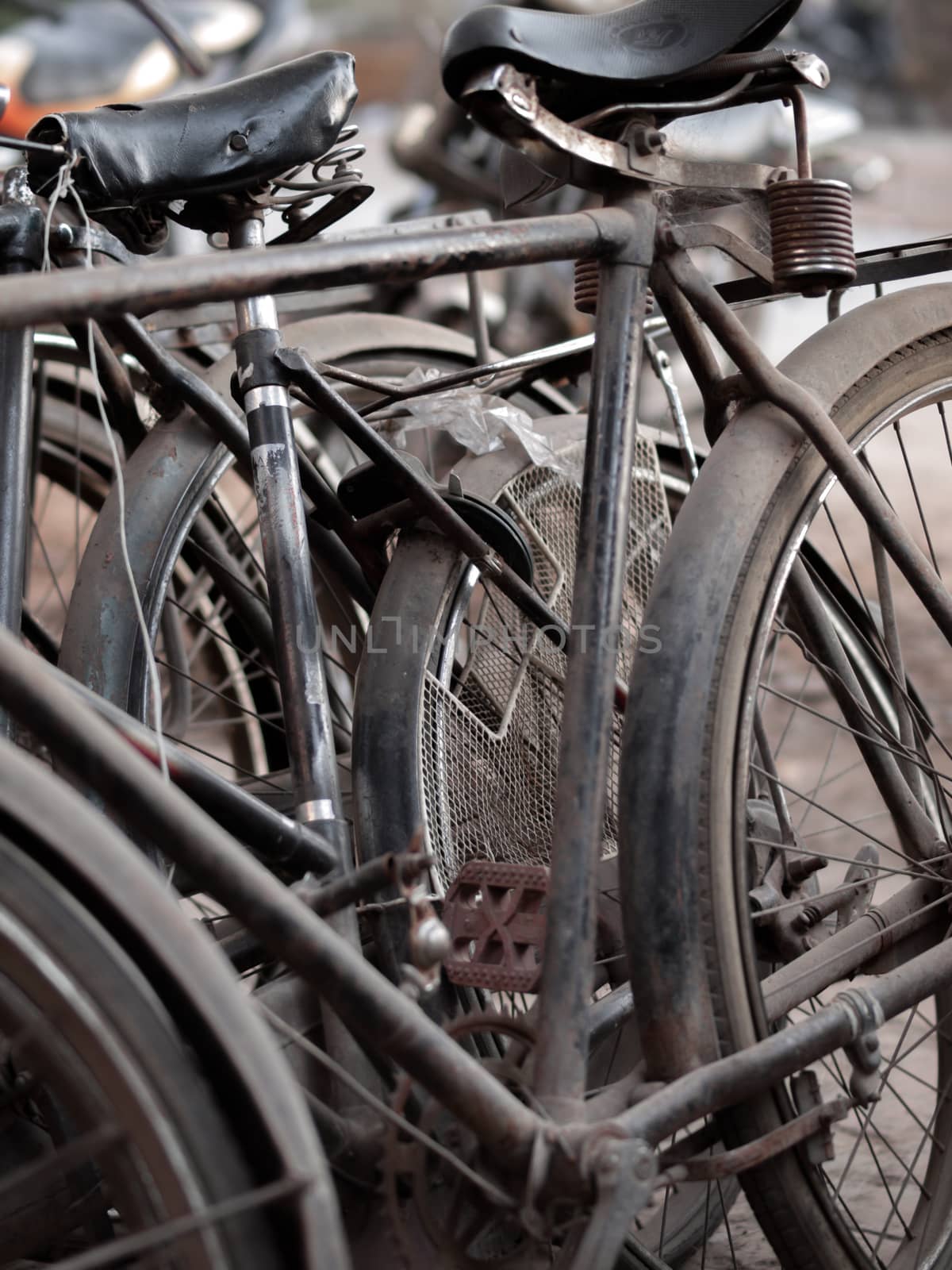 COLOR PHOTO OF ABSTRACT SHOT OF OLD RUSTY BICYCLE PARTS