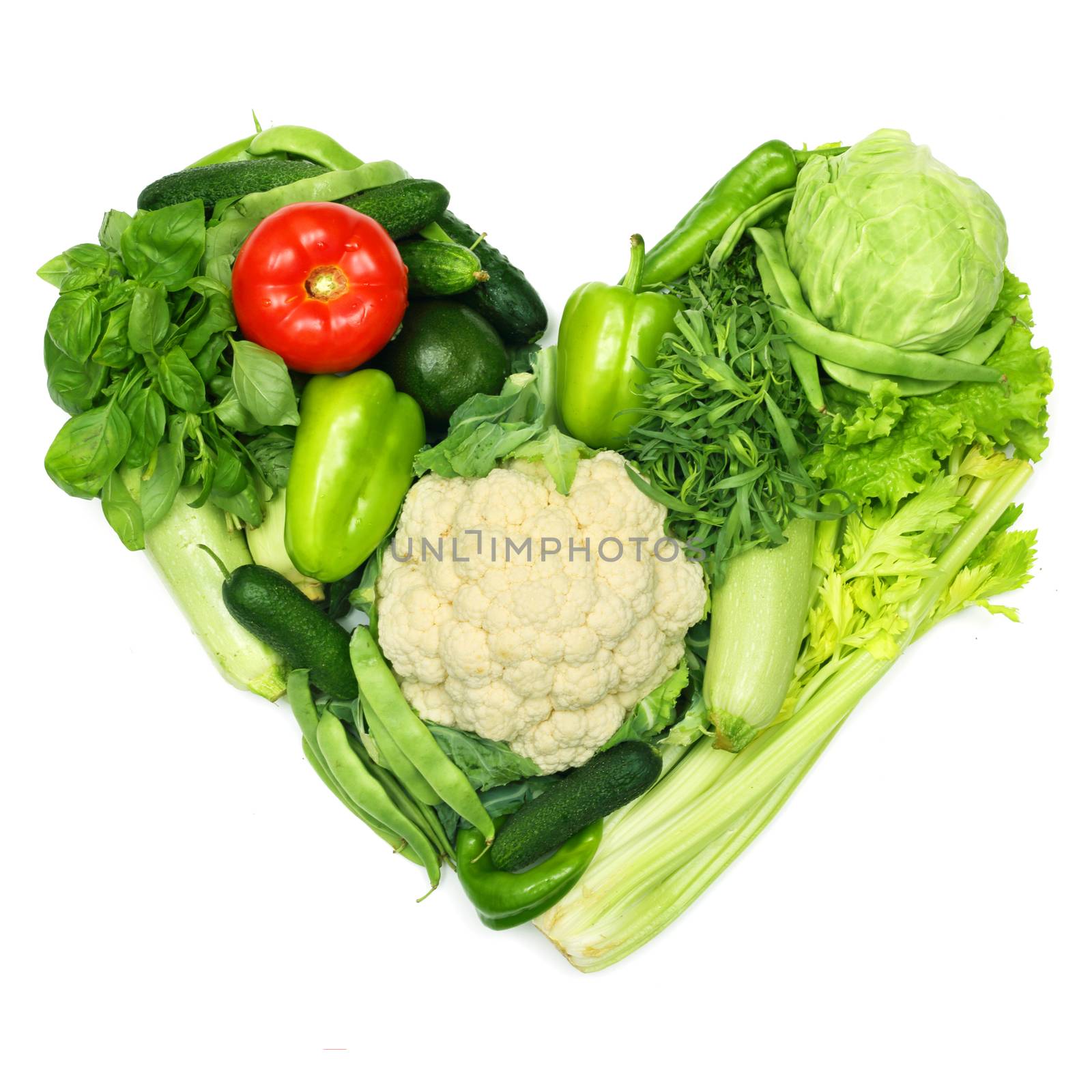 Love vegetables concept, pile of vegetables shaped as heart isolated on white background