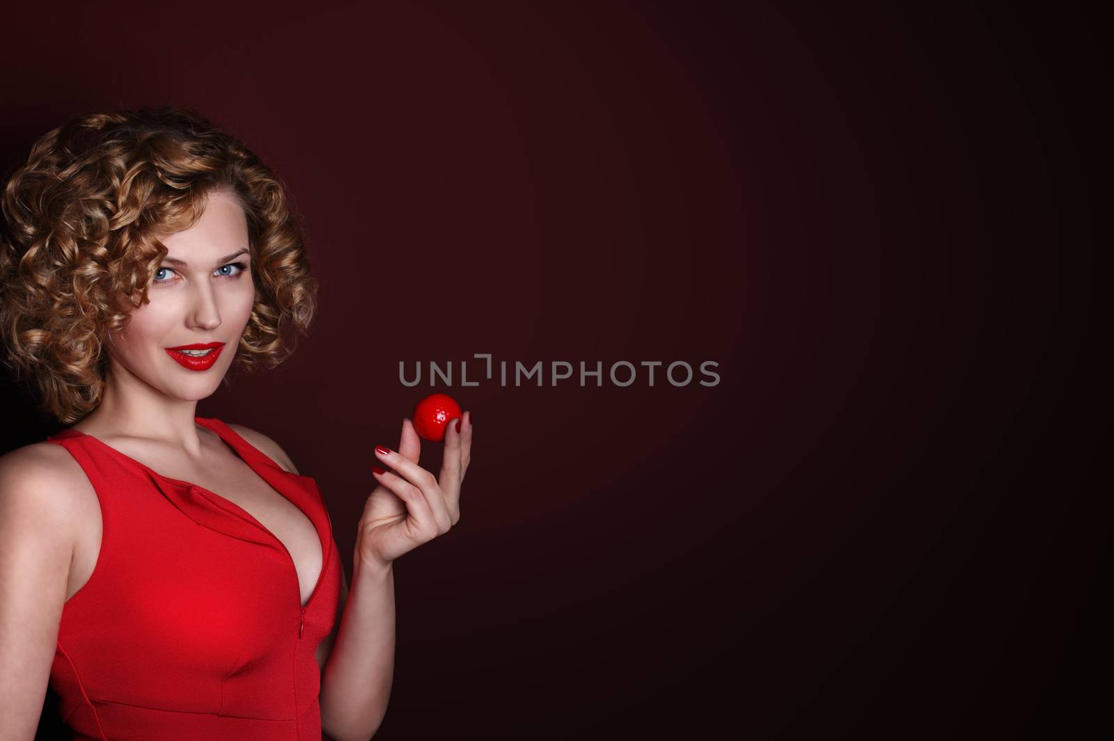 Beautiful woman holding red golf ball, luxury sport concept
